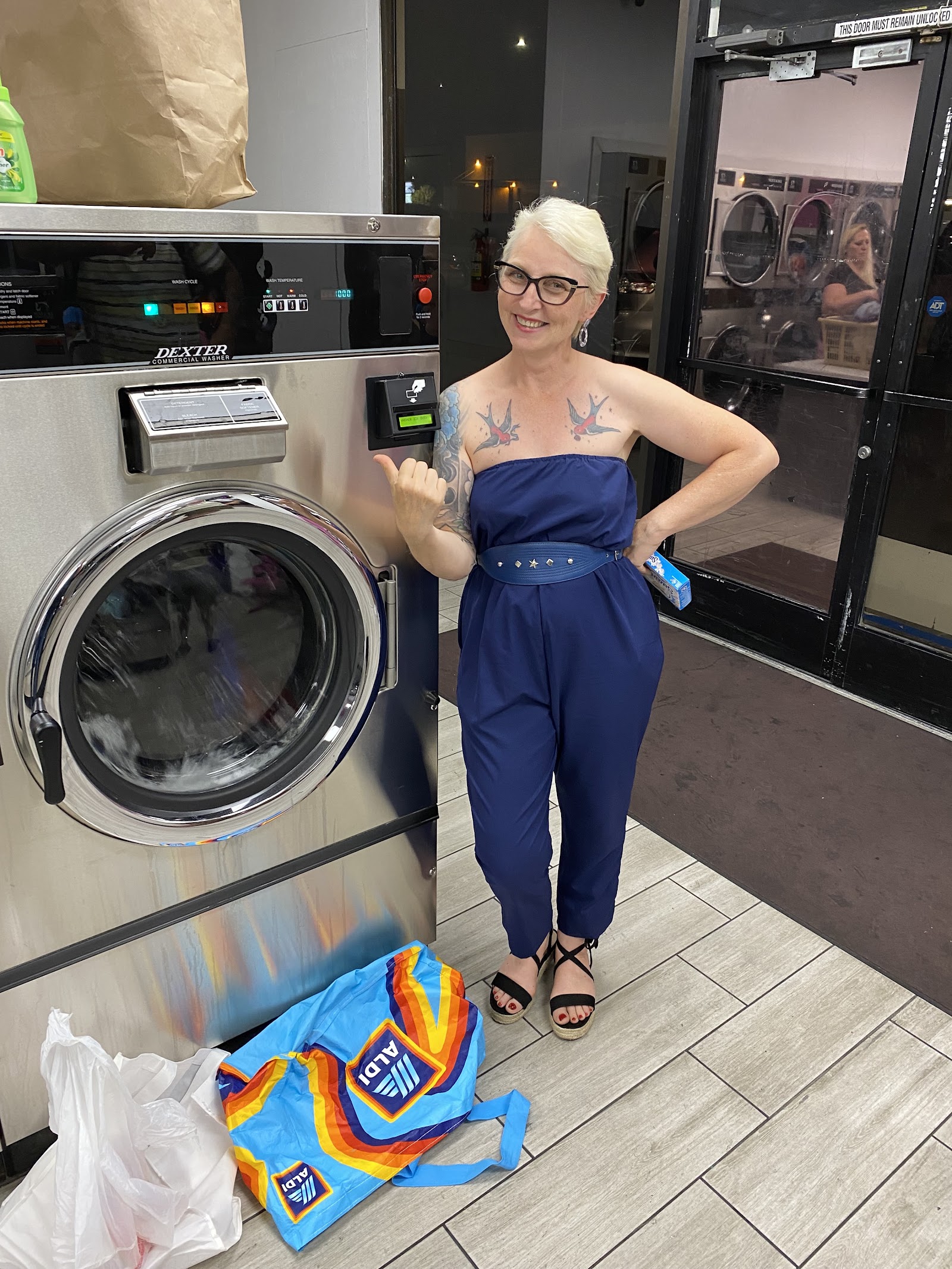 Customer smiling and pointing at a Dexter washer
