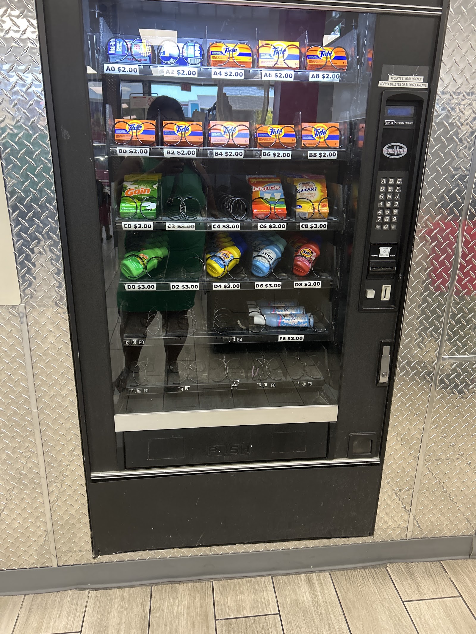Vending machine dispensing laundry detergent and supplies