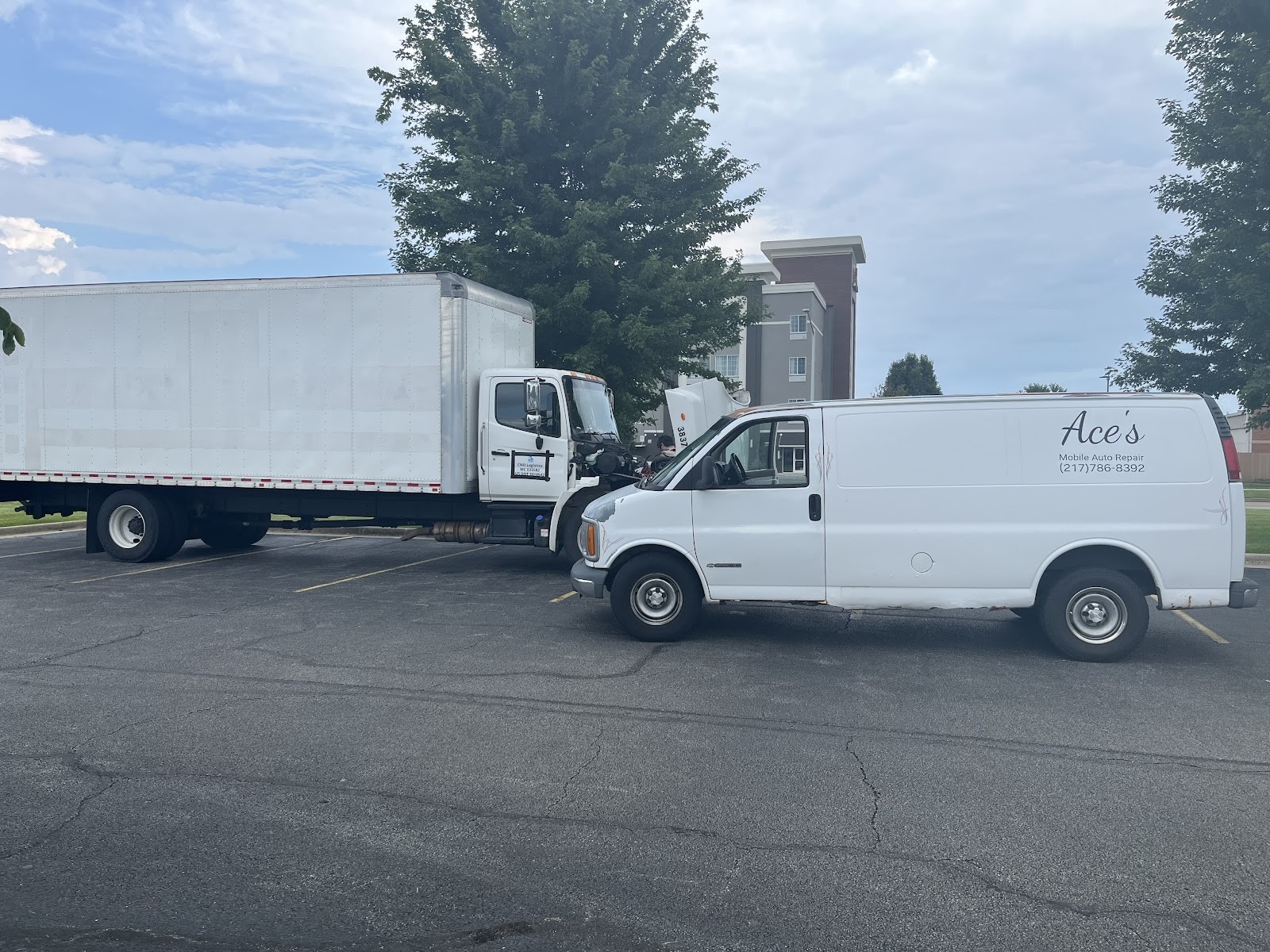 Ace's Mobile Auto Repair van next to a box truck in a parking lot