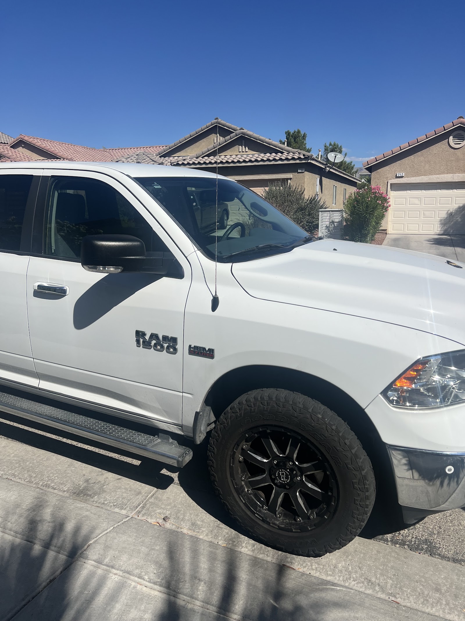 White Ram 1500 HEMI pickup truck parked in residential driveway