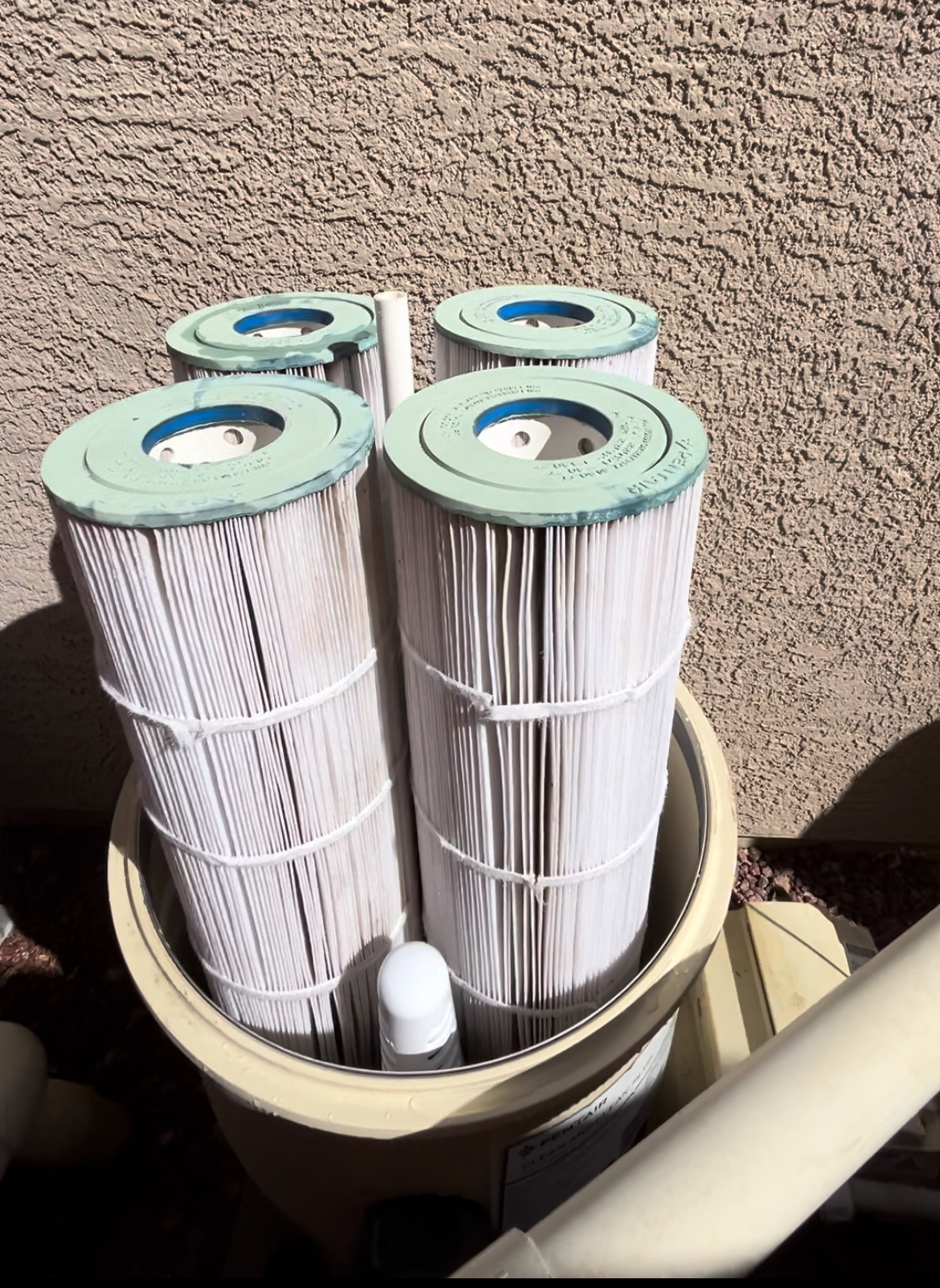 Clean white Pentair filter cartridges in housing after cleaning