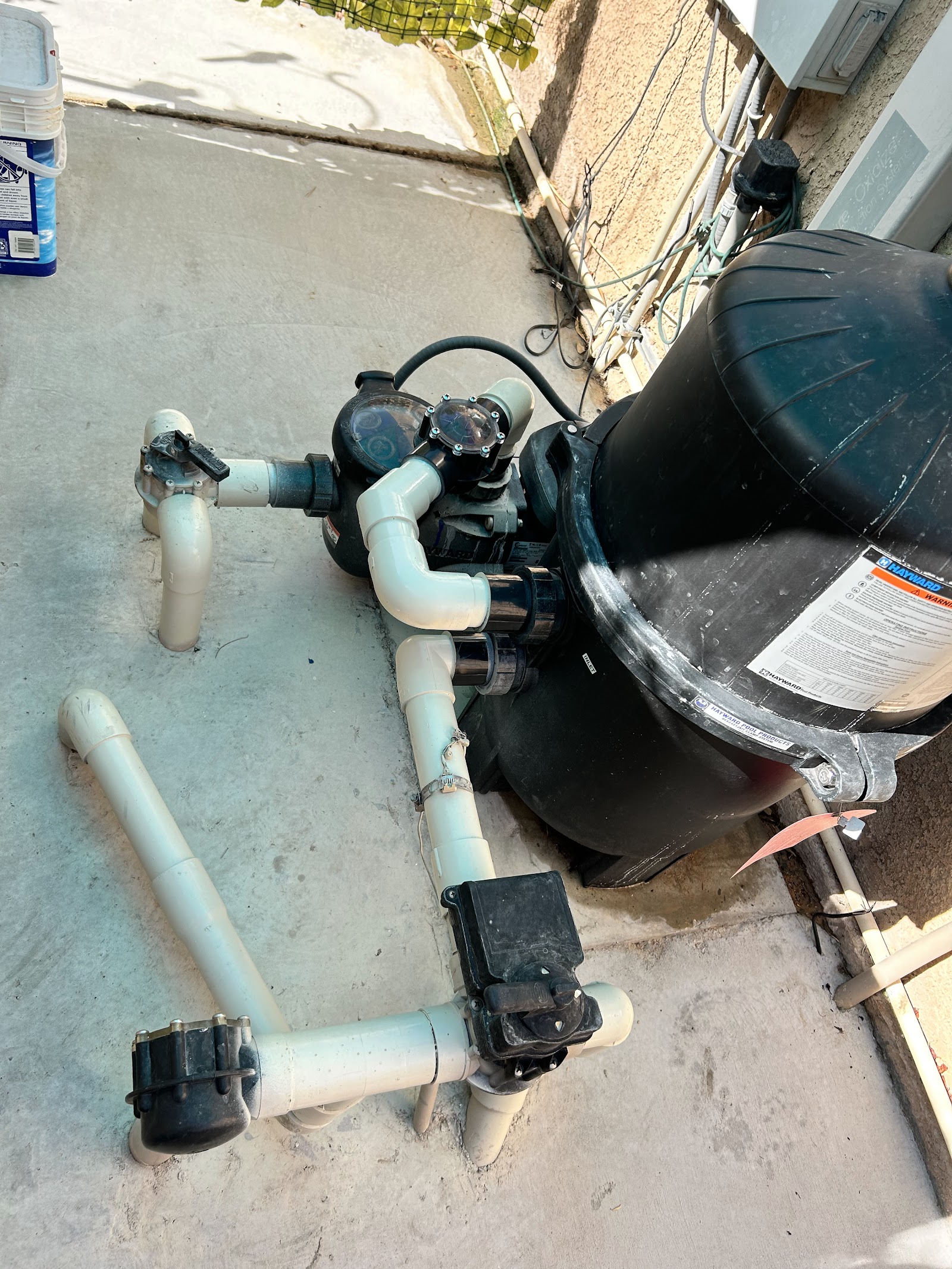 Hayward pool filter and pump plumbing system on concrete pad