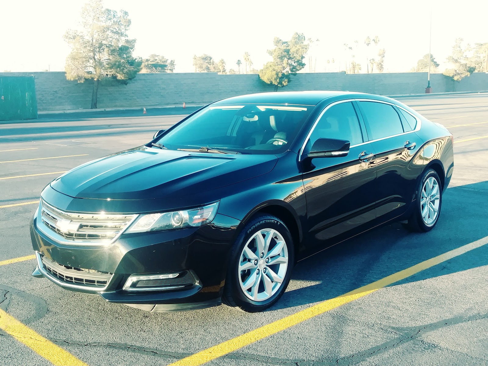 Freshly washed black Chevrolet Impala parked in lot