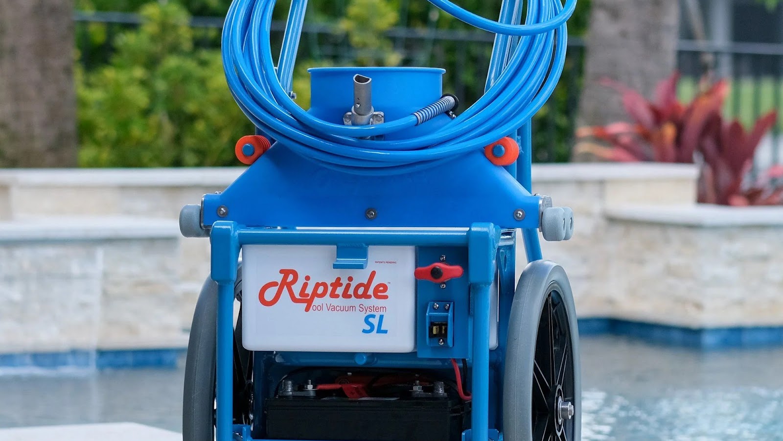 Close-up of Riptide SL pool vacuum system by a pool