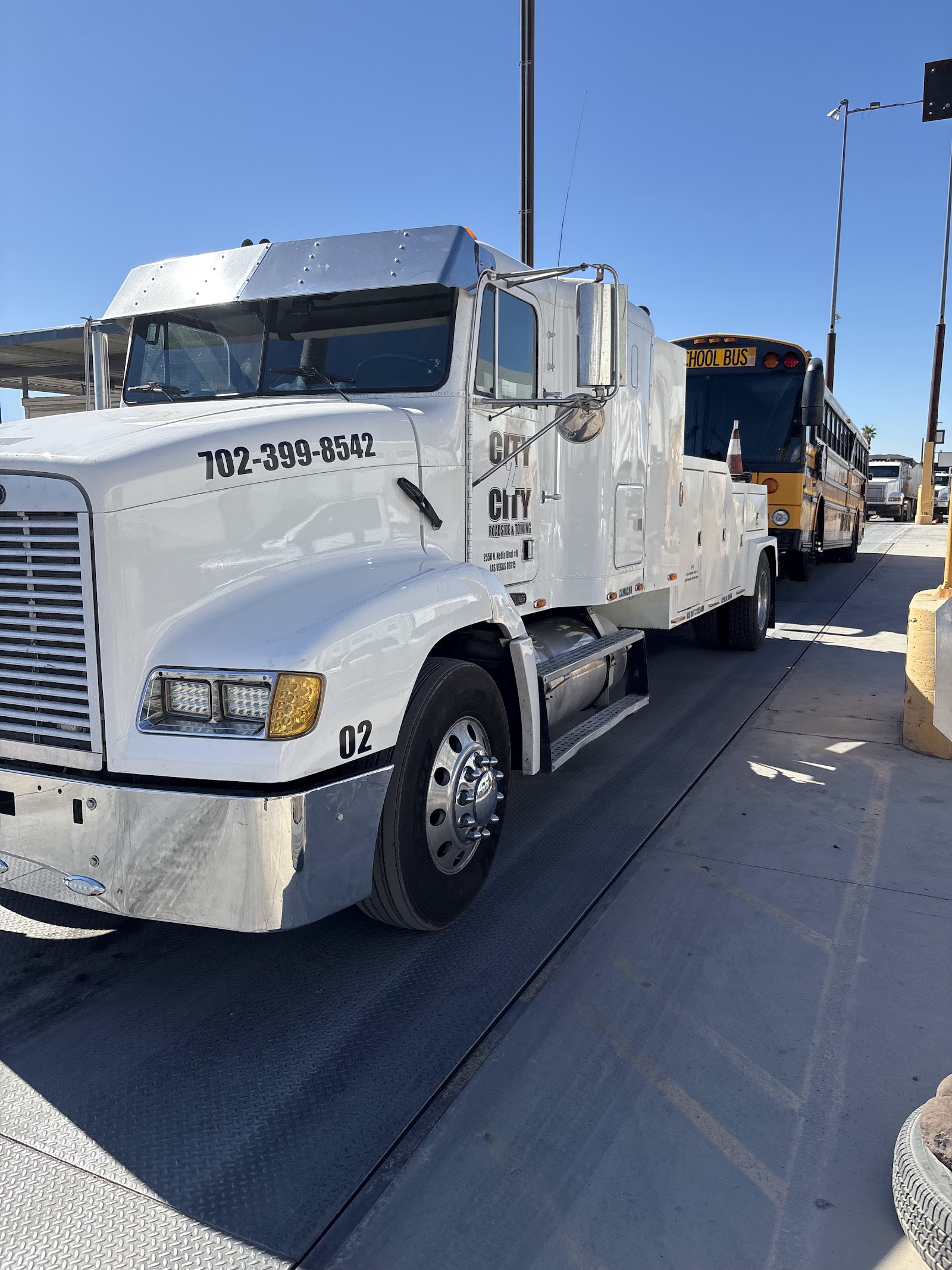 City 2 City white heavy-duty wow truck parked with visible phone number 702-399-8542