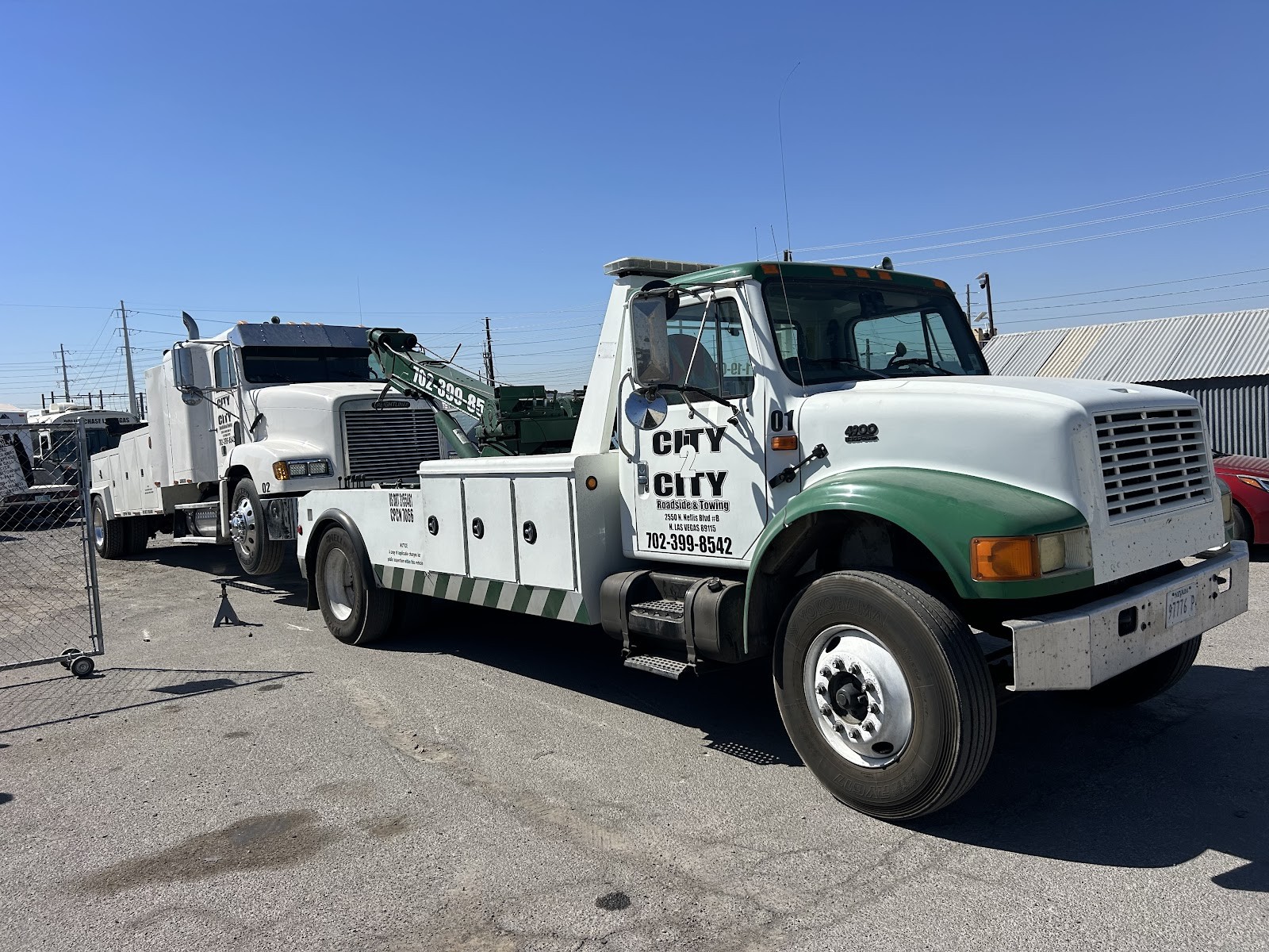 City 2 City green and white International wrecker truck #01 in the yard