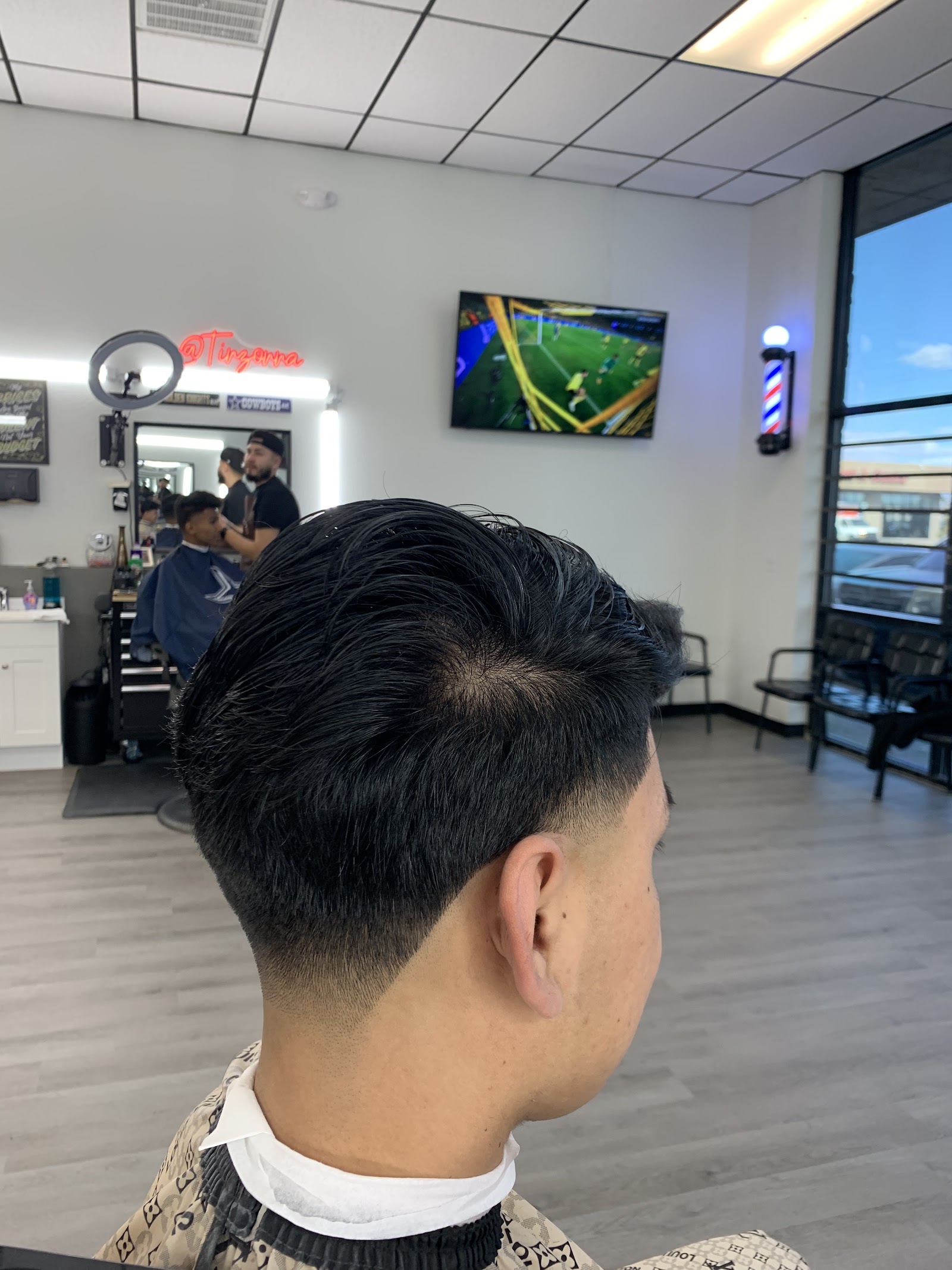 Side view of a men's flowing haircut with low taper fade