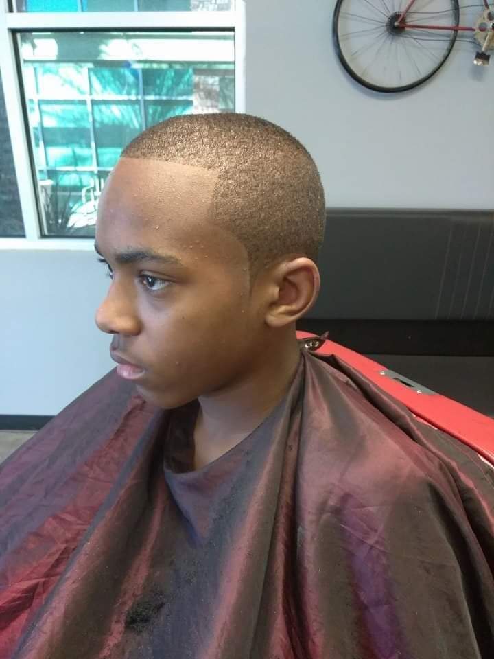 Side profile of young man with short fade haircut