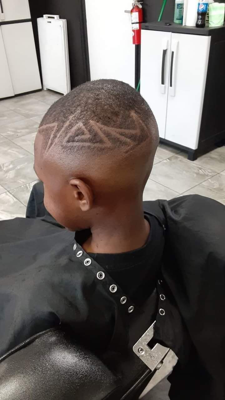 Back of a boy's head showing geometric star hair design
