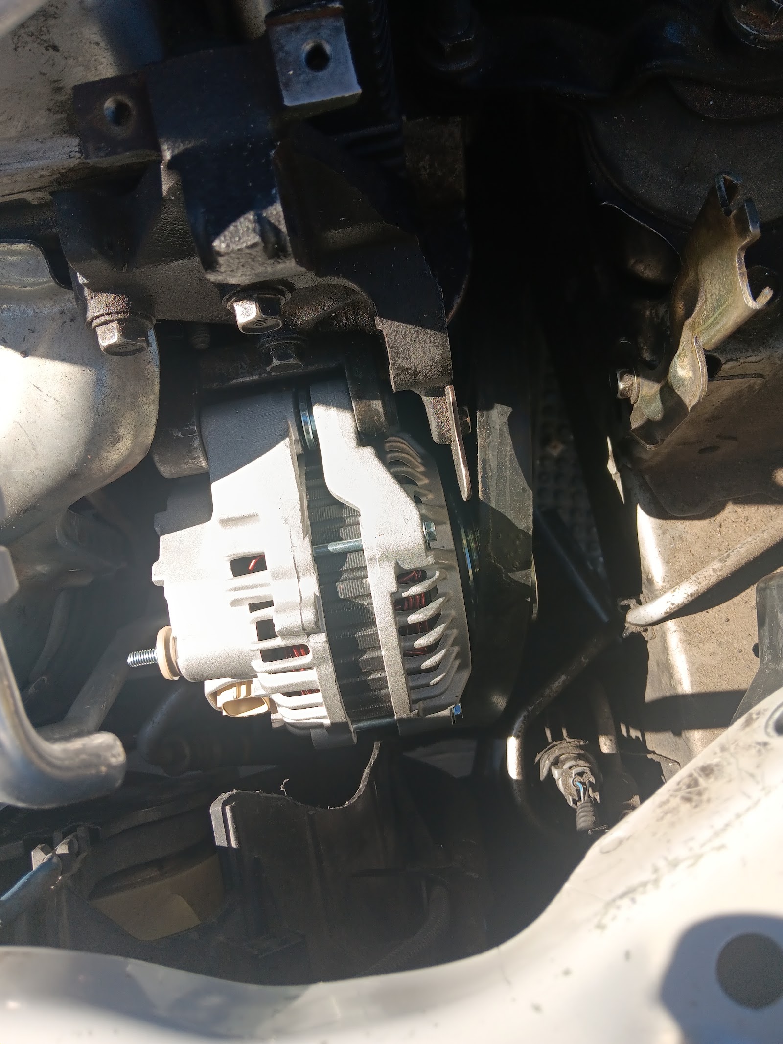 Newly installed alternator mounted in engine bay