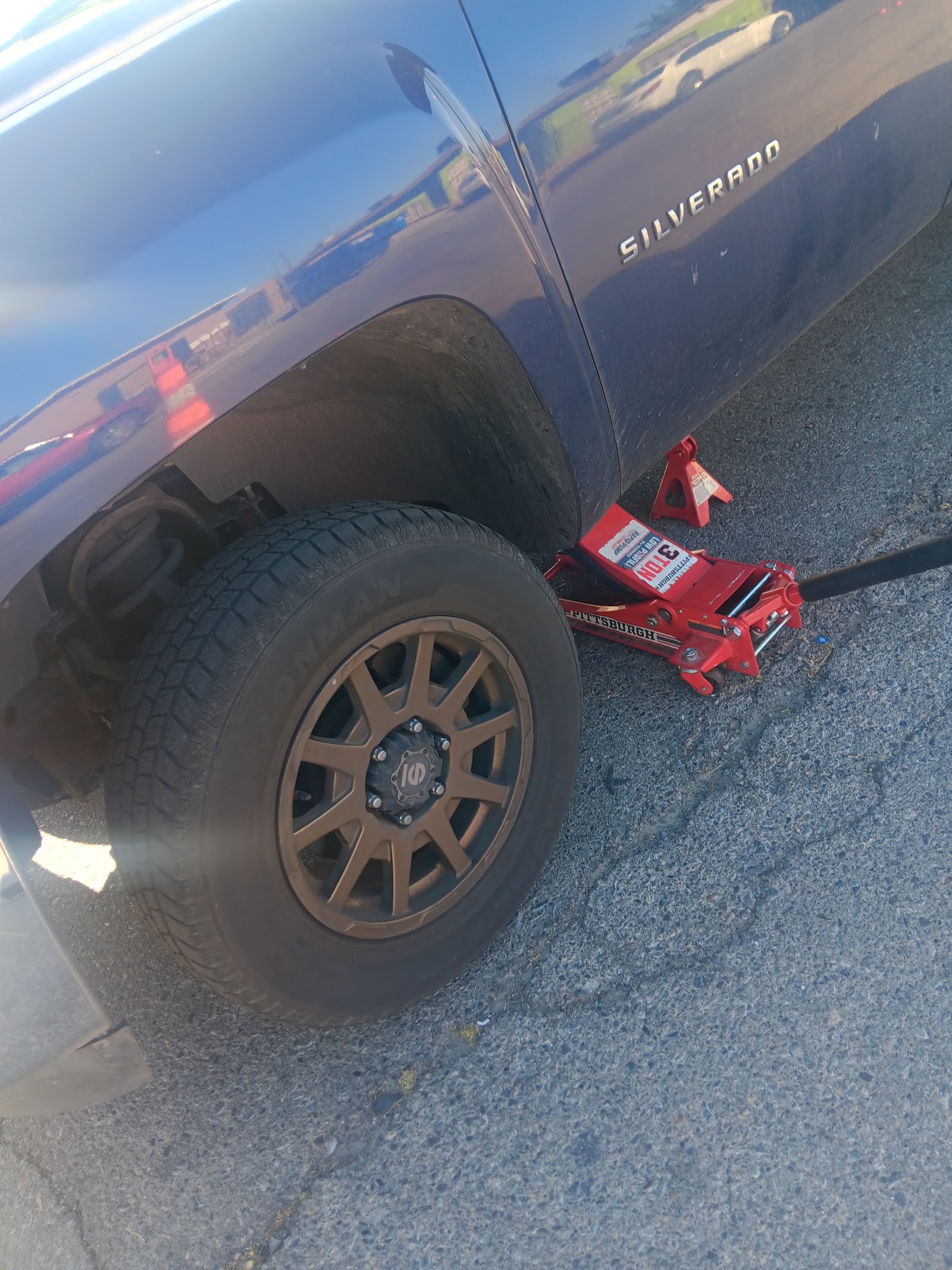 Chevrolet Silverado raised on a Pittsburgh floor jack and jack stand