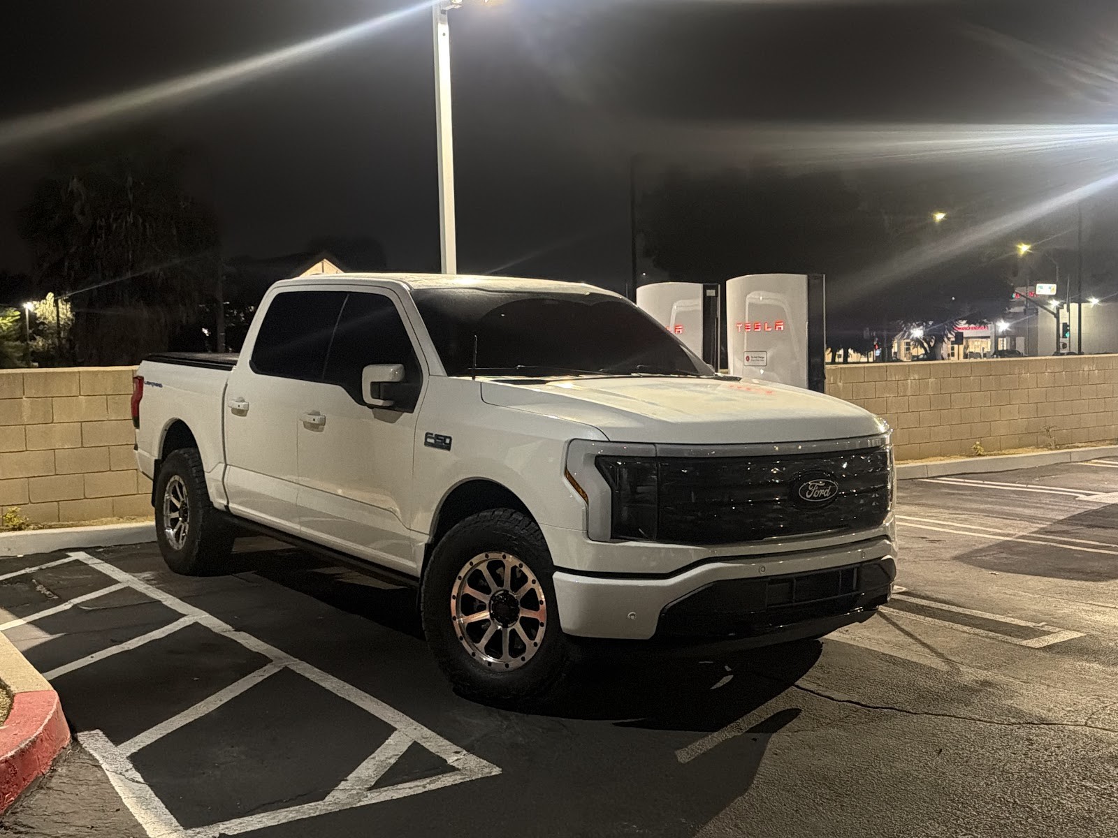 White Ford F-150 Lightning at night after detailing