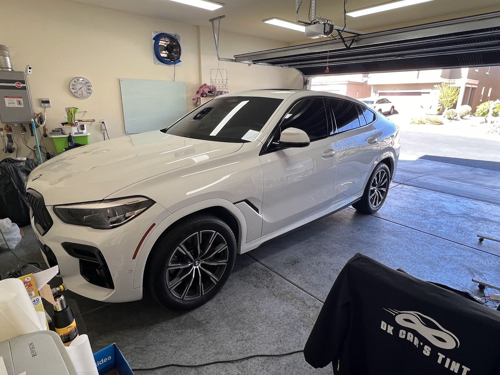 White BMW X6 with tinted windows in the tinting garage