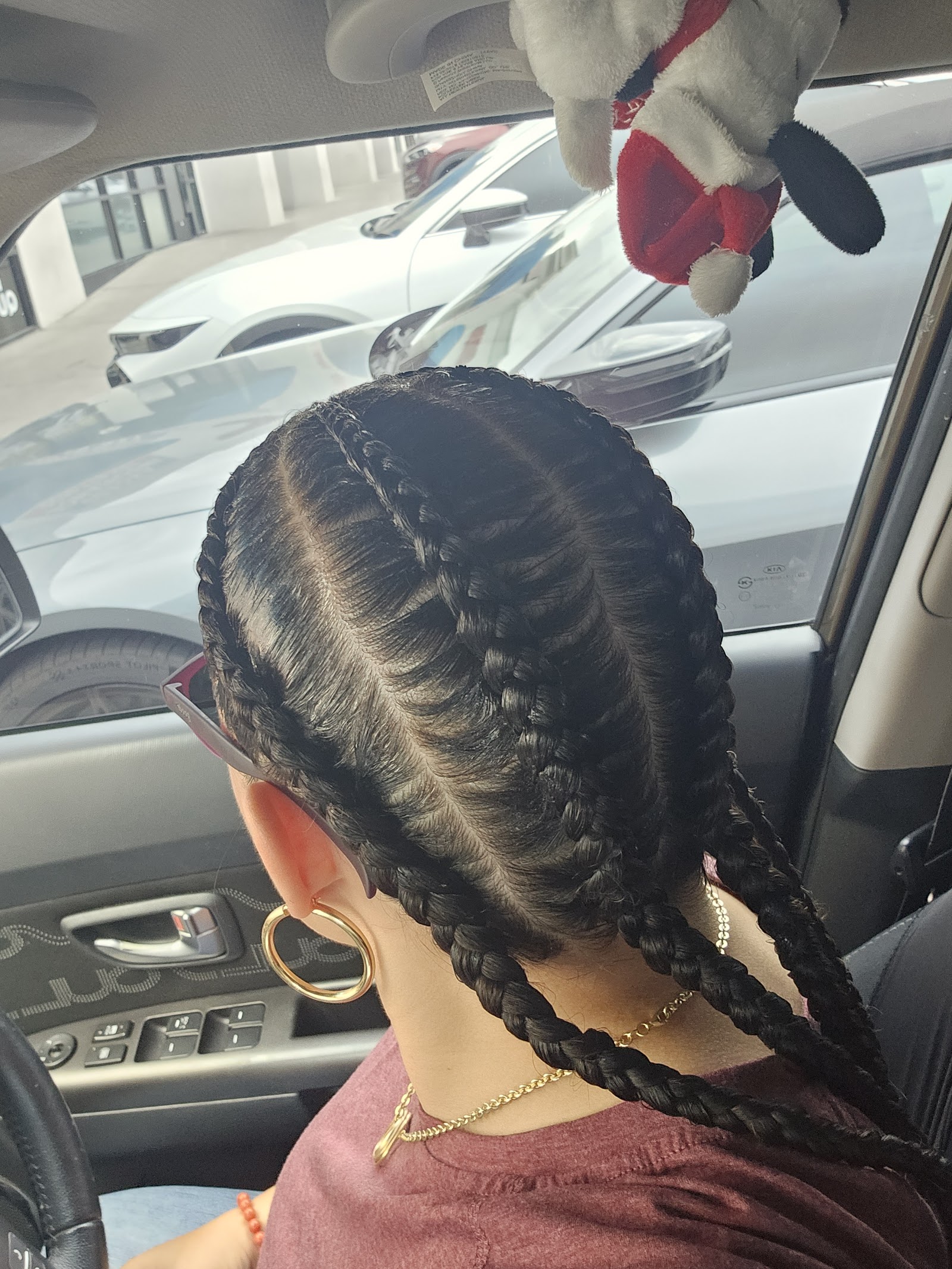Two sleek cornrow braids styled close to the scalp, rear view