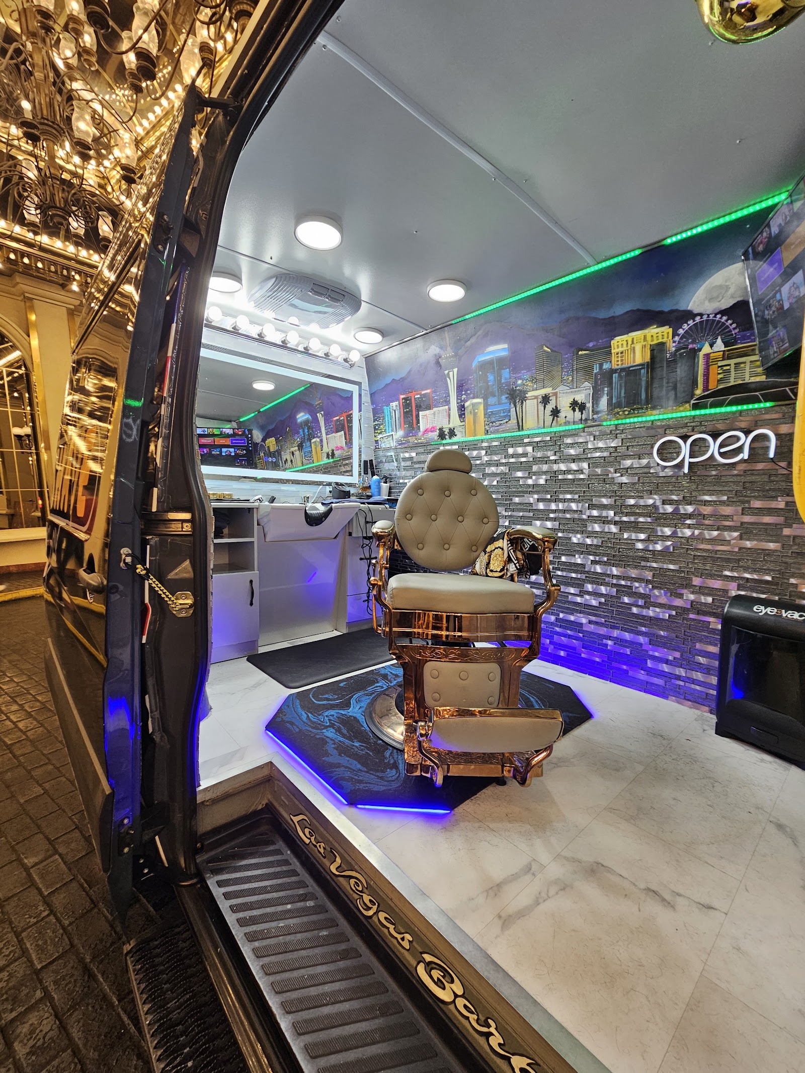 Interior of luxury mobile barbershop van with gold barber chair and Las Vegas skyline mural