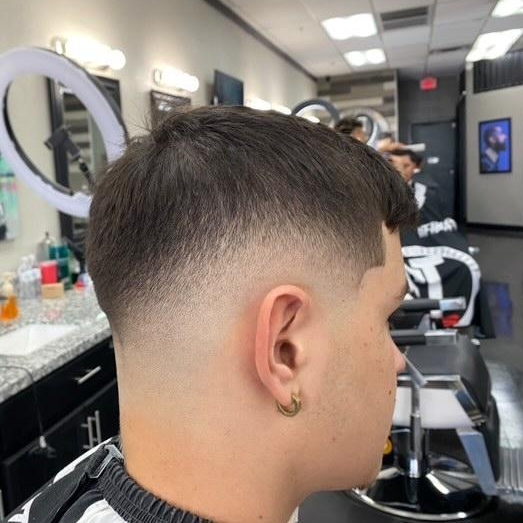 Side profile of a clean low fade haircut in the barbershop