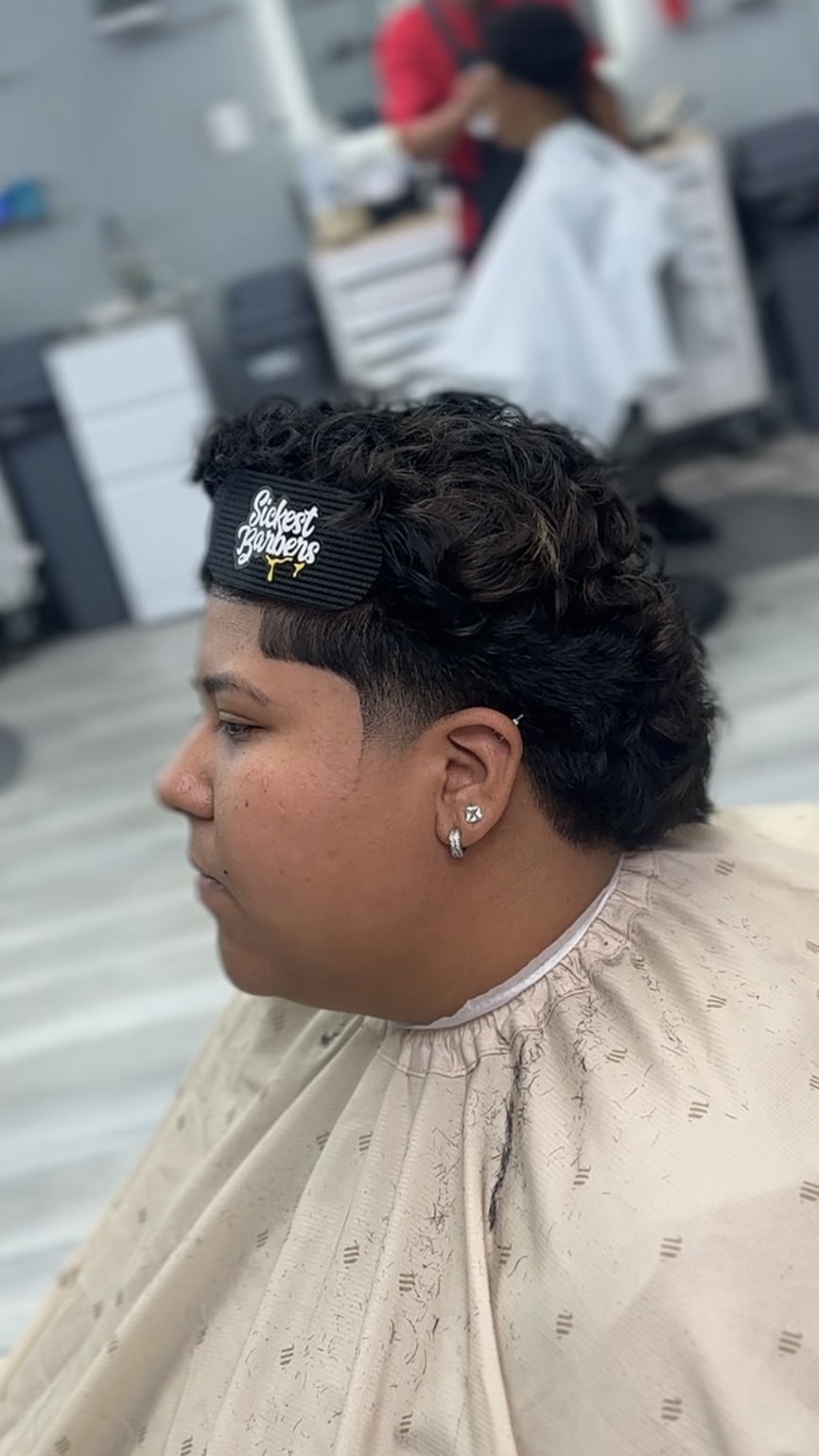Client with curly mullet-style cut and taper at the shop
