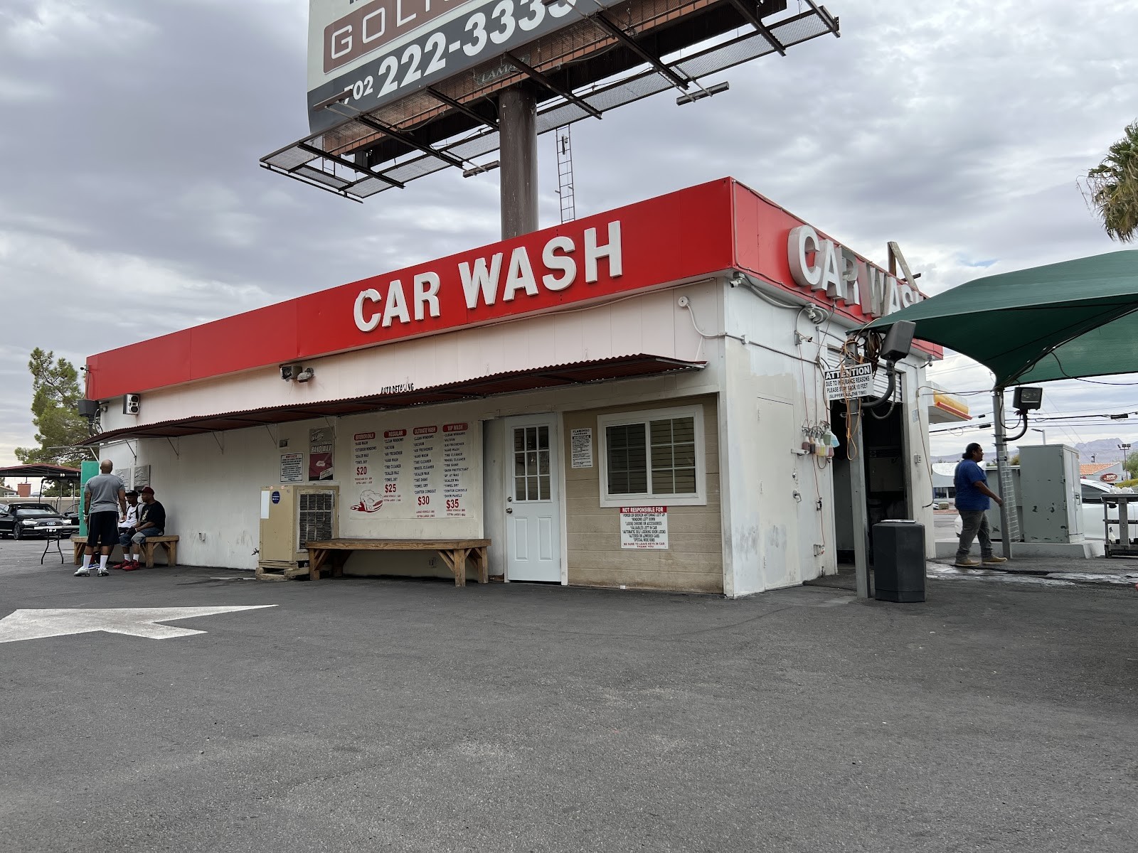 Exterior of the CAR WASH building with red signage and billboard