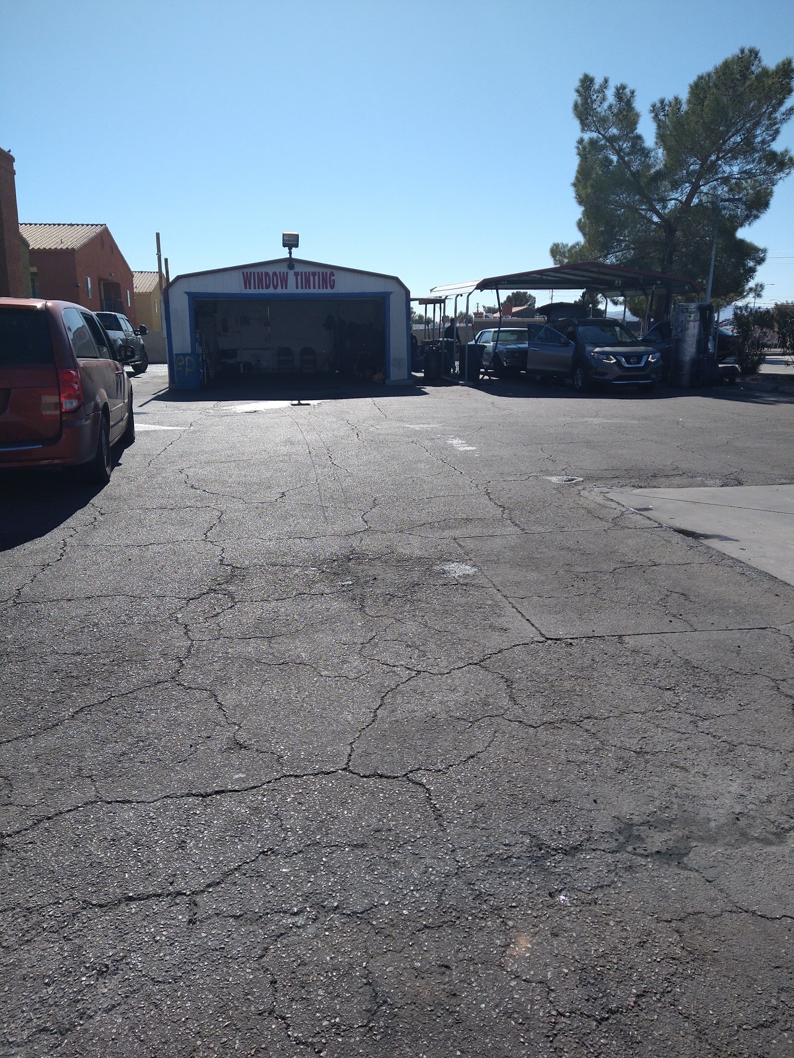 Window tinting garage and covered wash bays with cracked lot