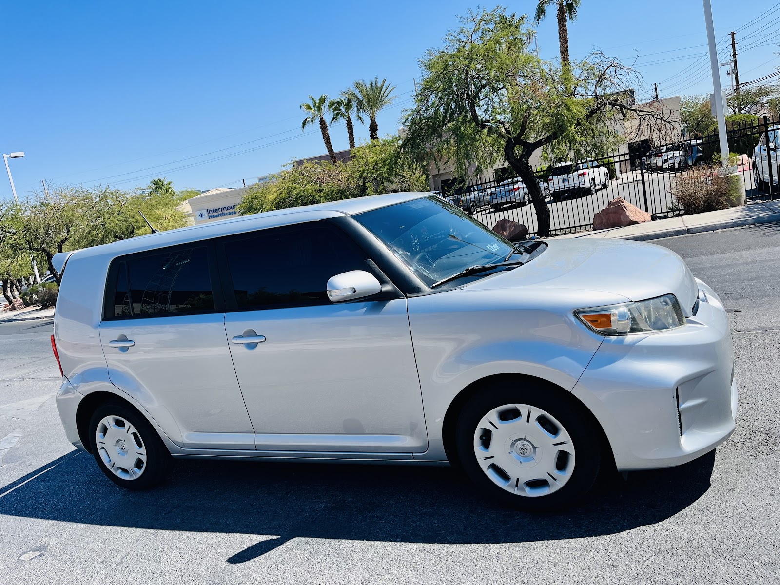 Silver Scion xB with tinted windows parked outdoors on a sunny day