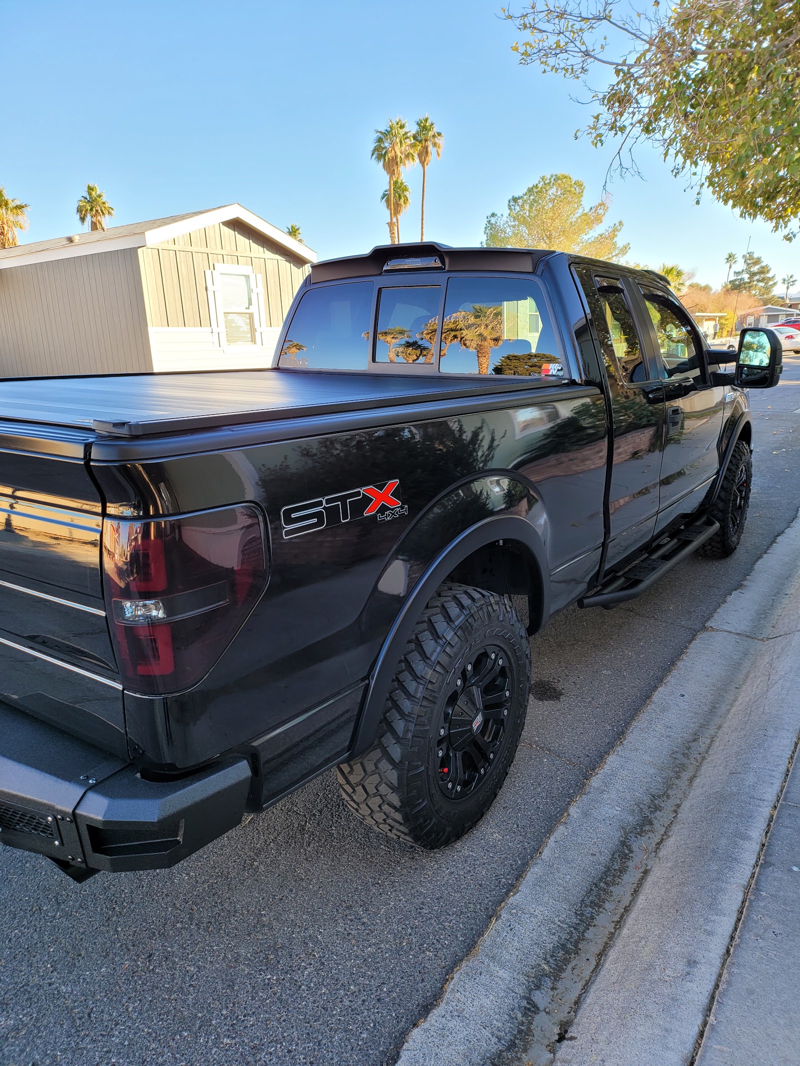 Freshly washed black Ford F-150 STX 4x4 with shiny finish