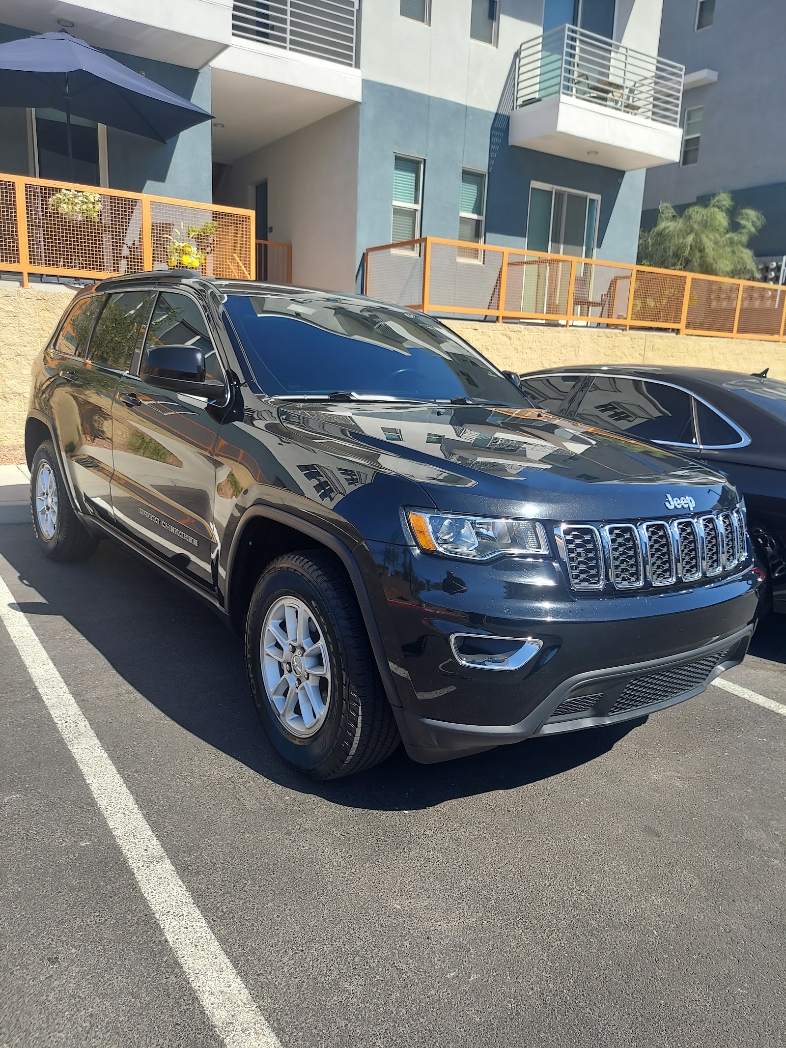 Clean black Jeep Grand Cherokee with reflective glossy finish