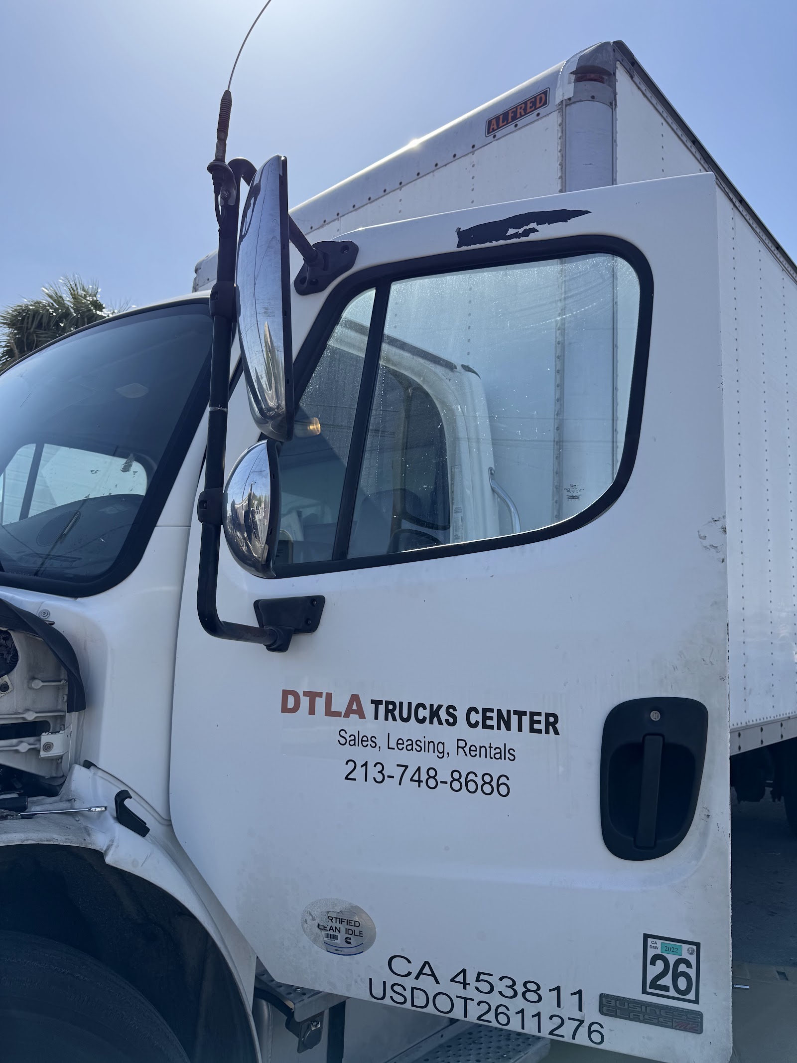 White box truck door reading DTLA Trucks Center with phone 213-748-8686