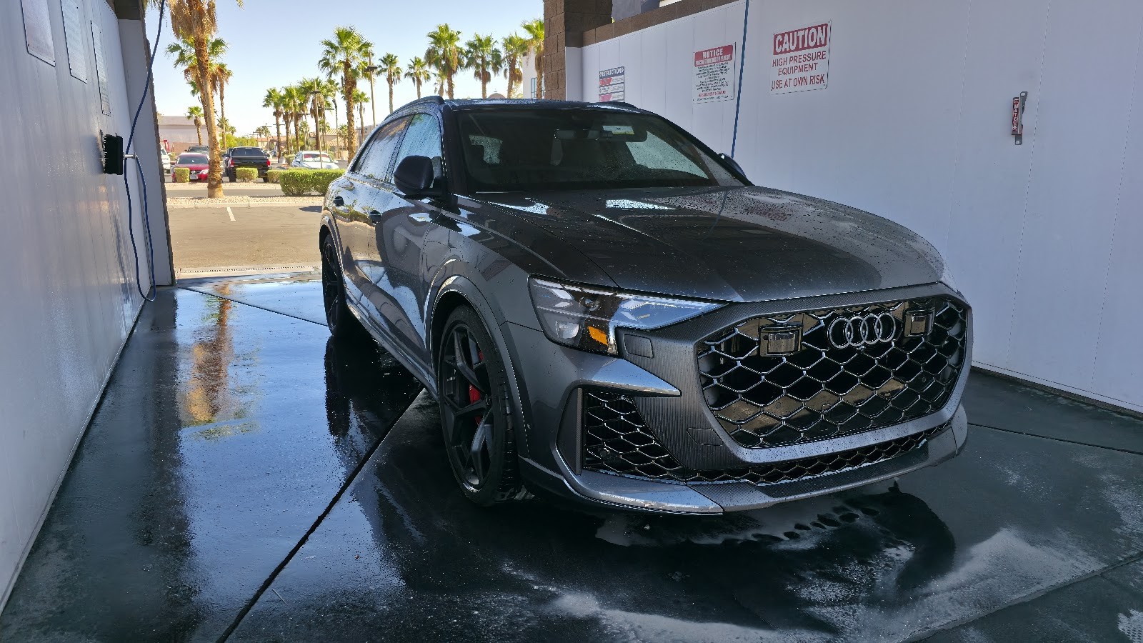 Grey Audi RS Q8 SUV being washed at self-serve bay