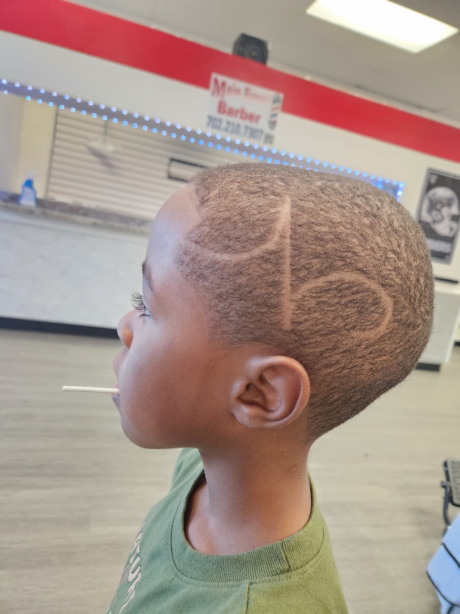 Side profile of young boy with hair design detailing and fade haircut