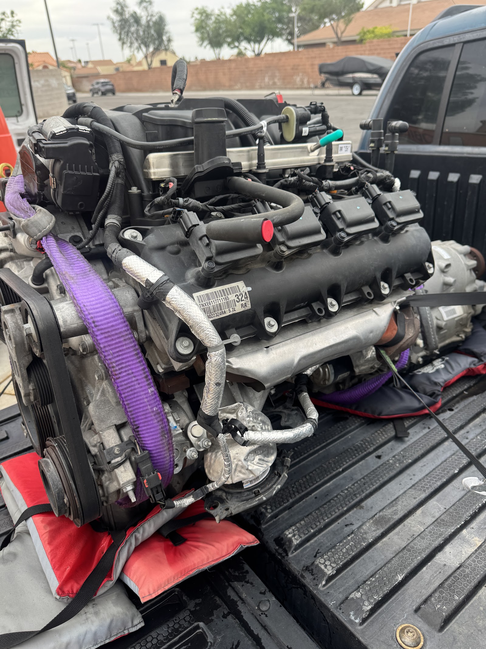 5.7L V8 engine strapped in a truck bed for transport or swap