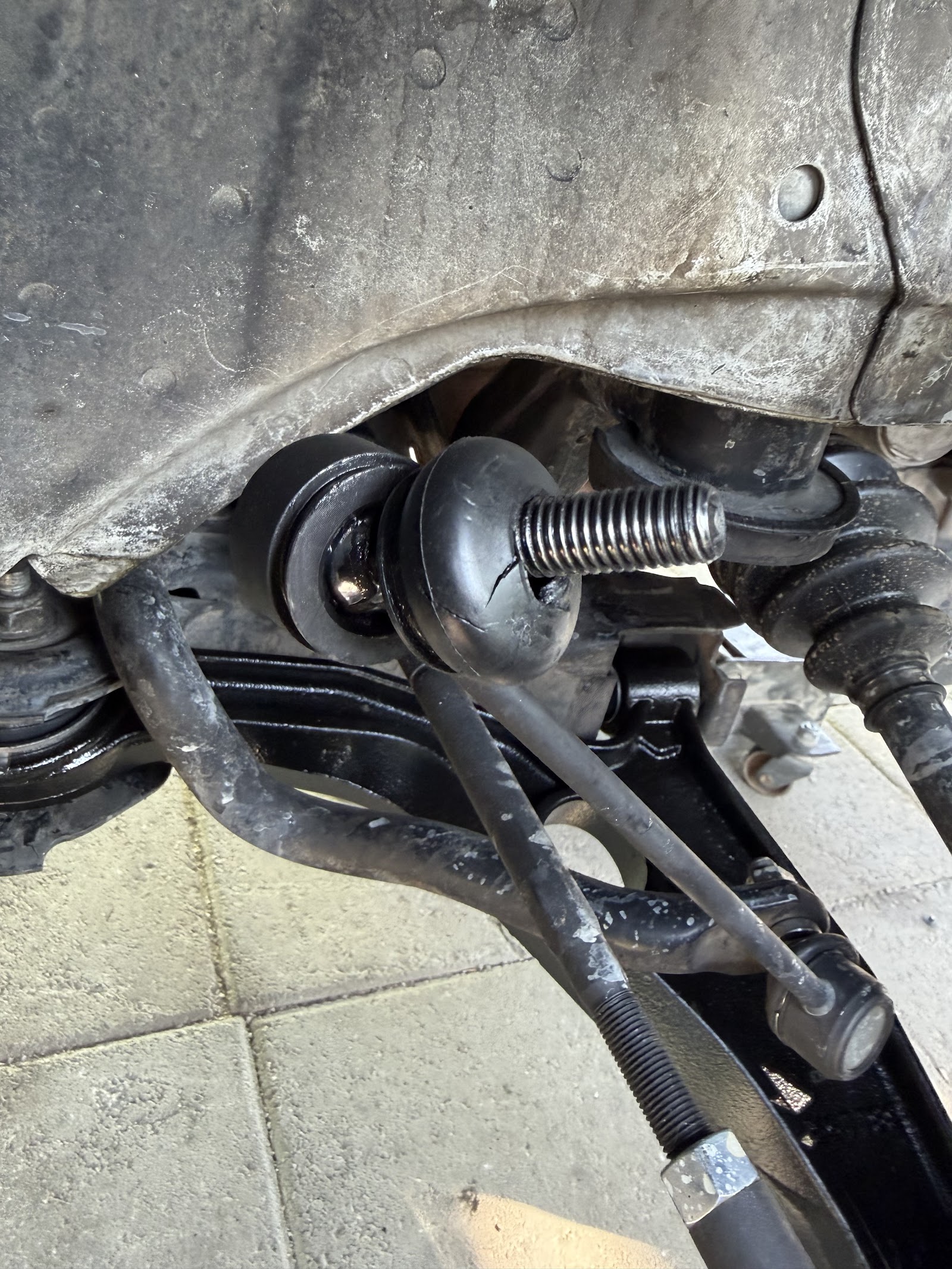 Underside suspension components with cracked ball joint boot