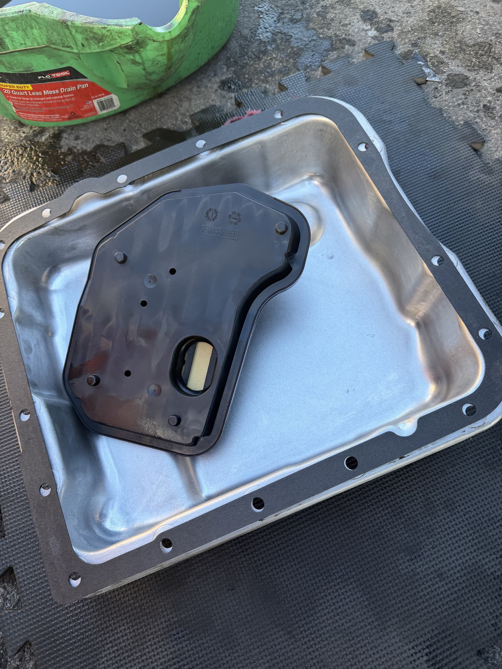 Transmission pan and filter during service on shop mat