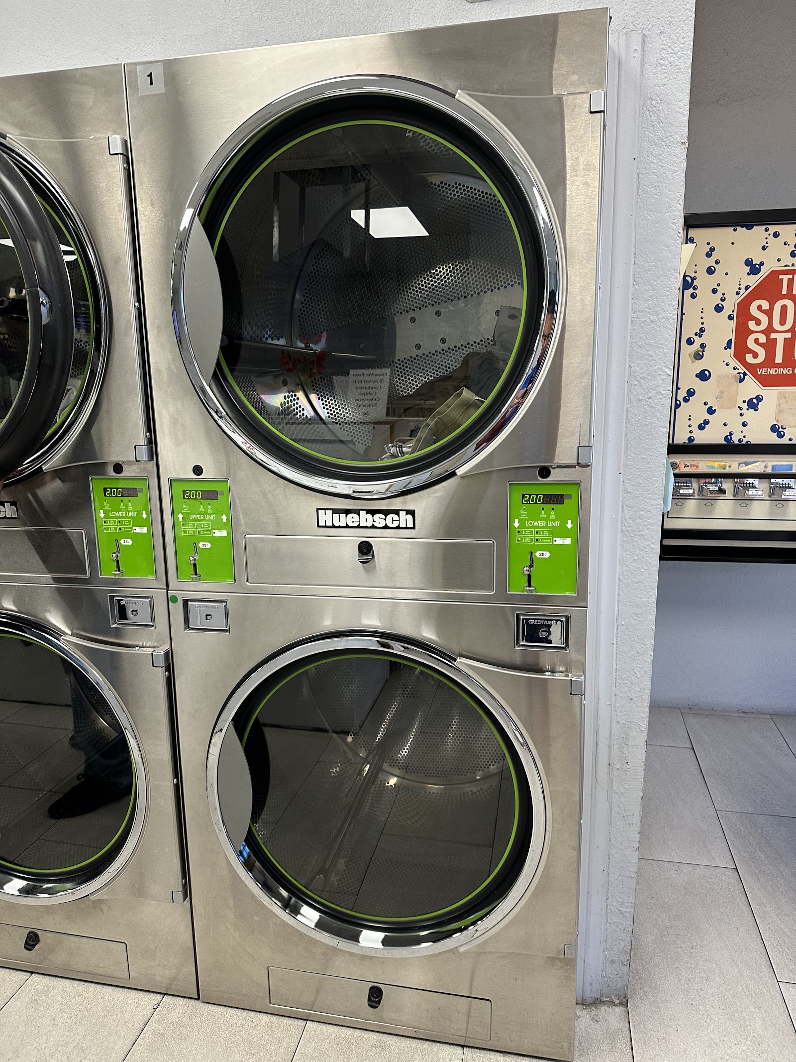 Stacked Huebsch stackable dryers with green control panels