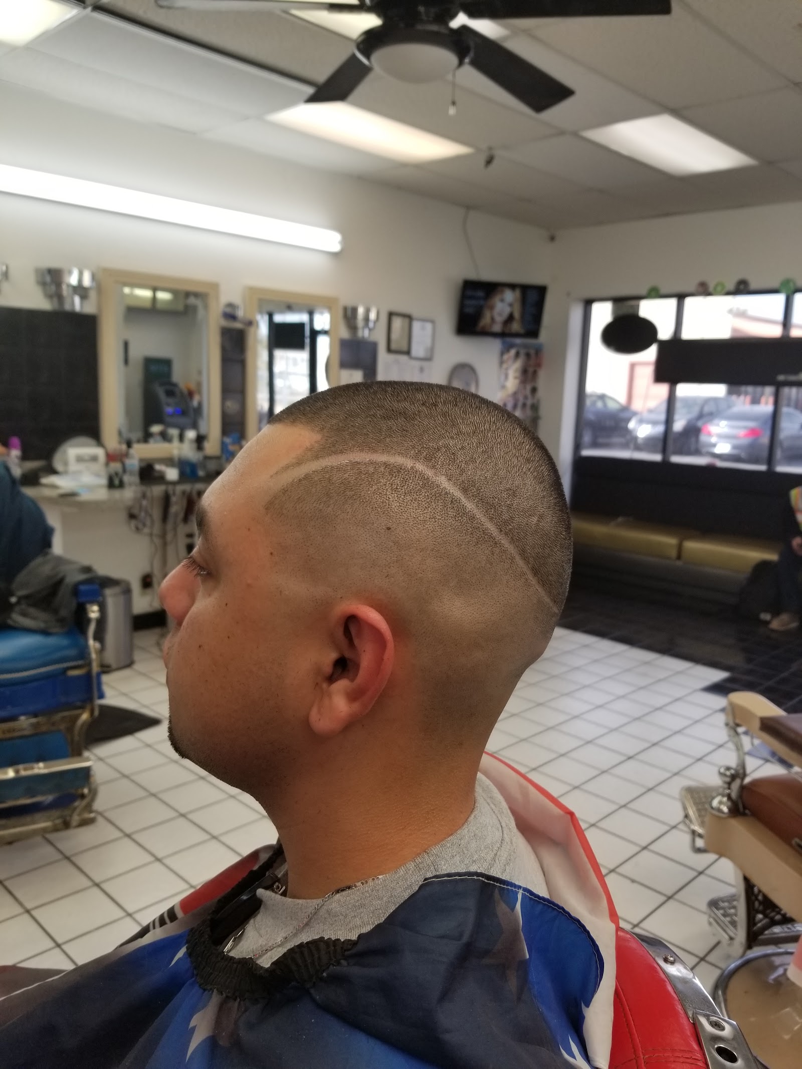 Side view of a man's fresh buzz cut with hair design line and clean fade