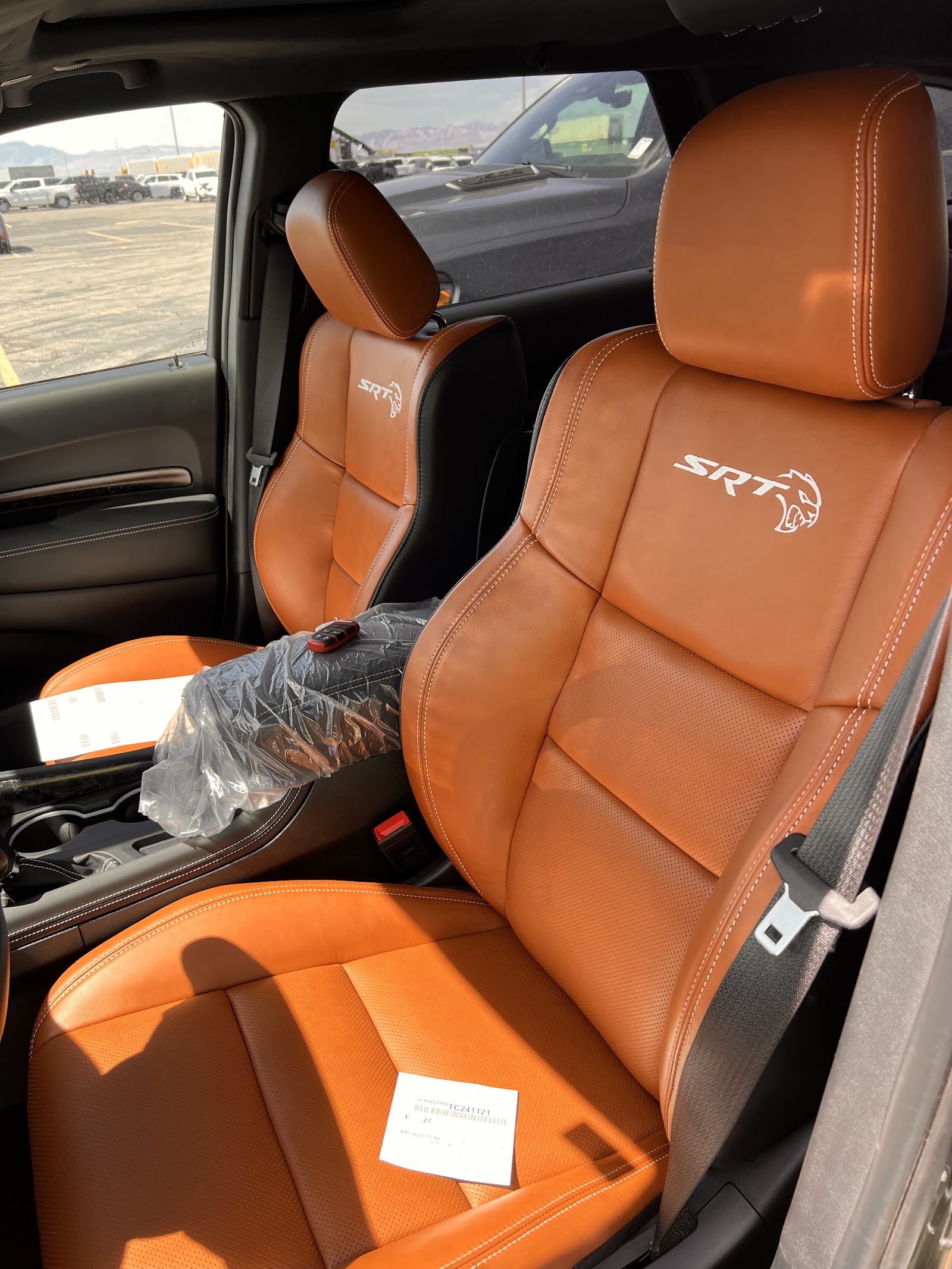 Orange and black SRT leather seats inside a Dodge/Jeep vehicle