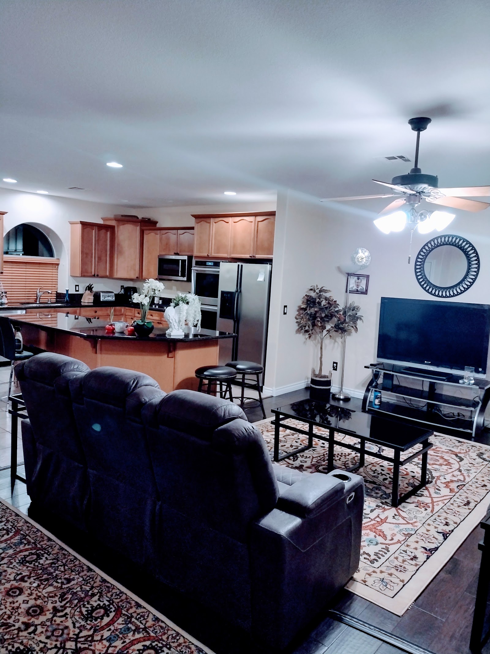 Open-concept living room and kitchen with cleaned and organized furniture