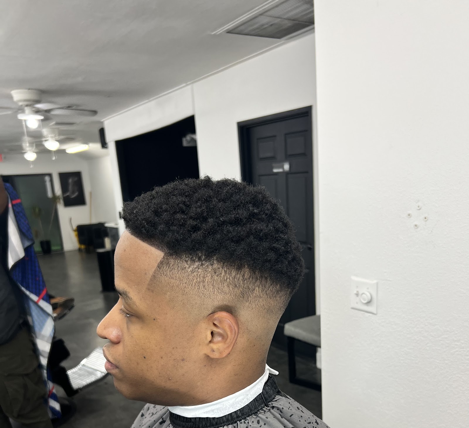 Side view of afro with clean line-up and drop fade