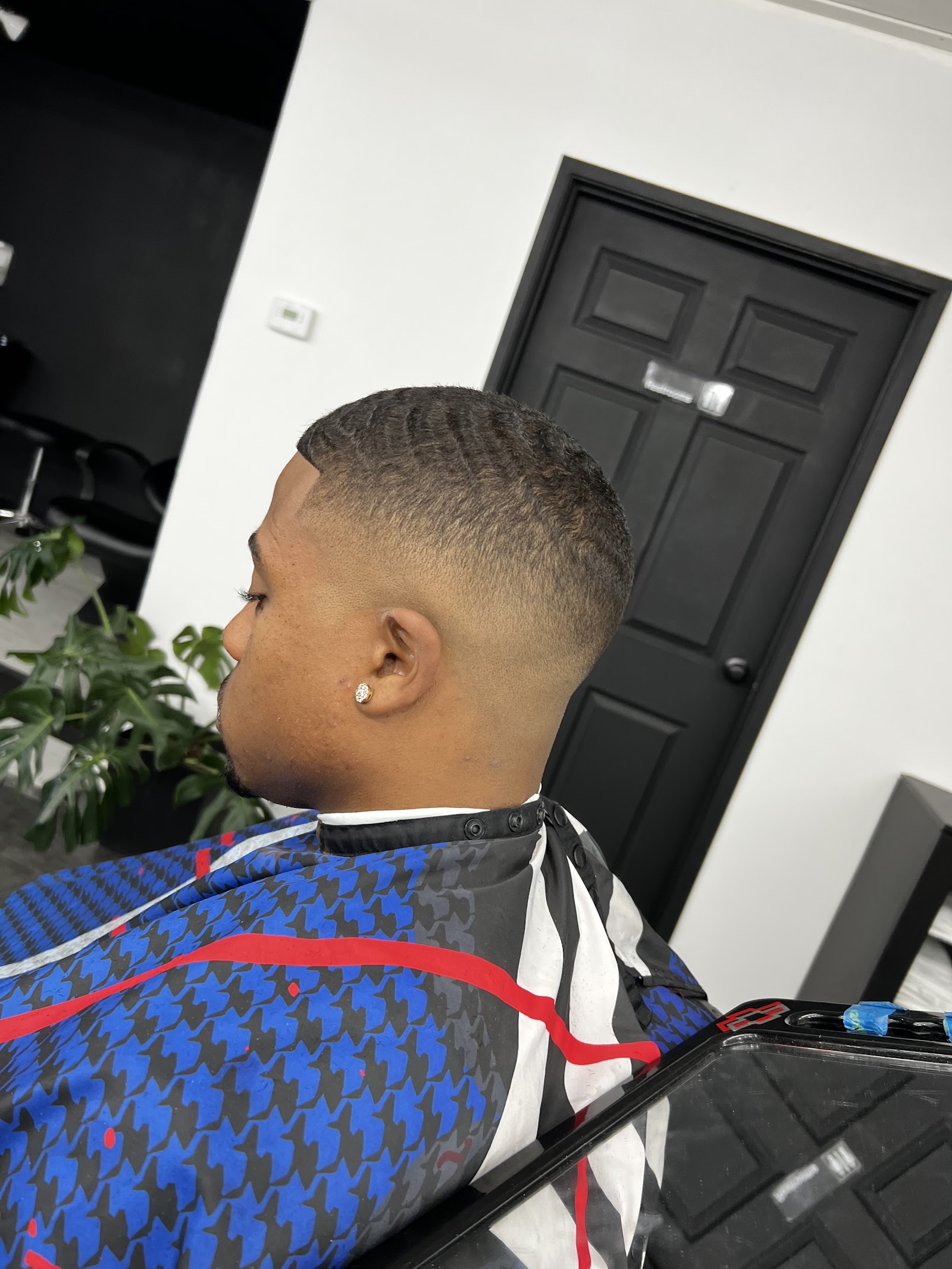 Side profile of man with 360 waves and clean skin fade