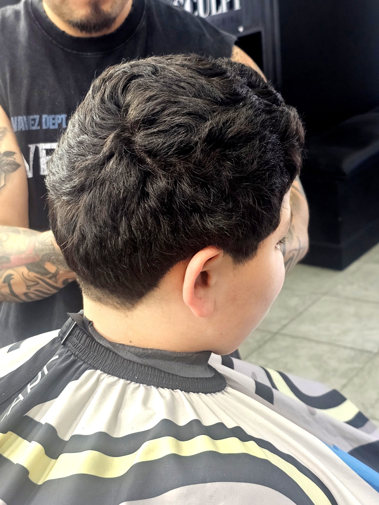 Back view of textured tapered haircut on client