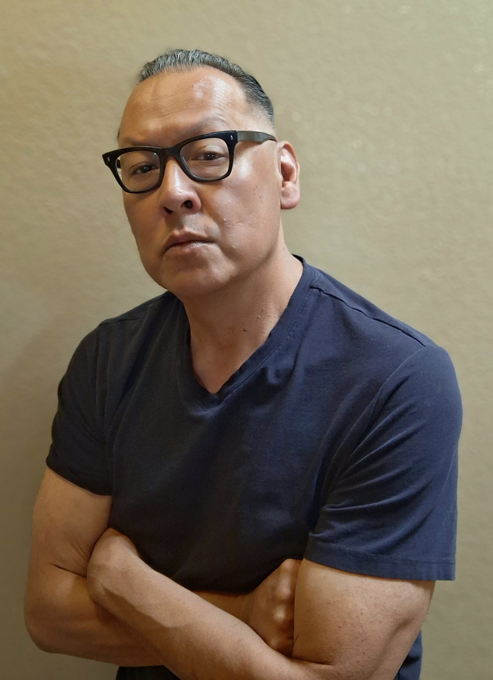 Front view of a man with fresh haircut and glasses