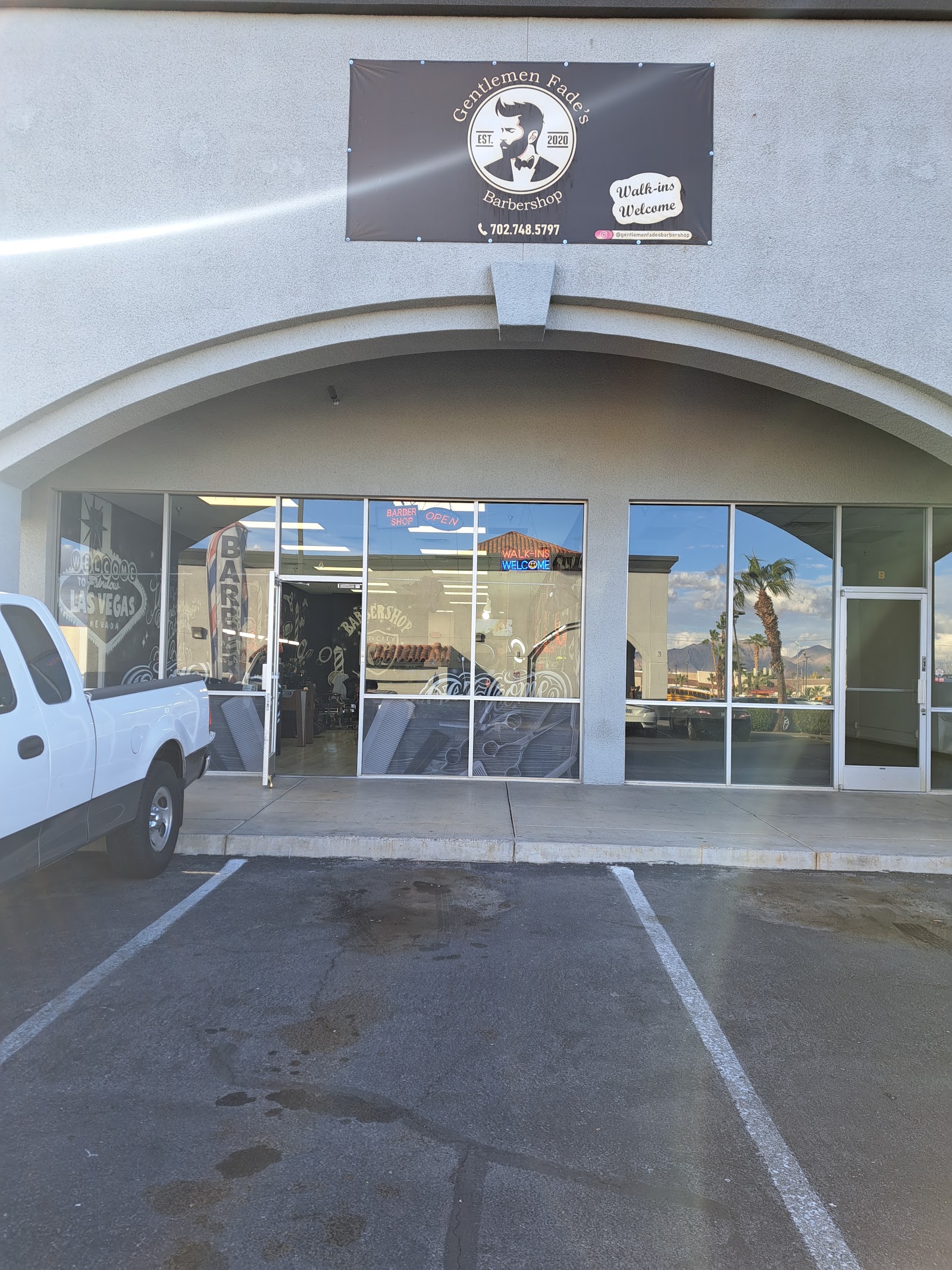 Exterior of Gentlemen Fade's Barbershop with signage and walk-ins welcome banner