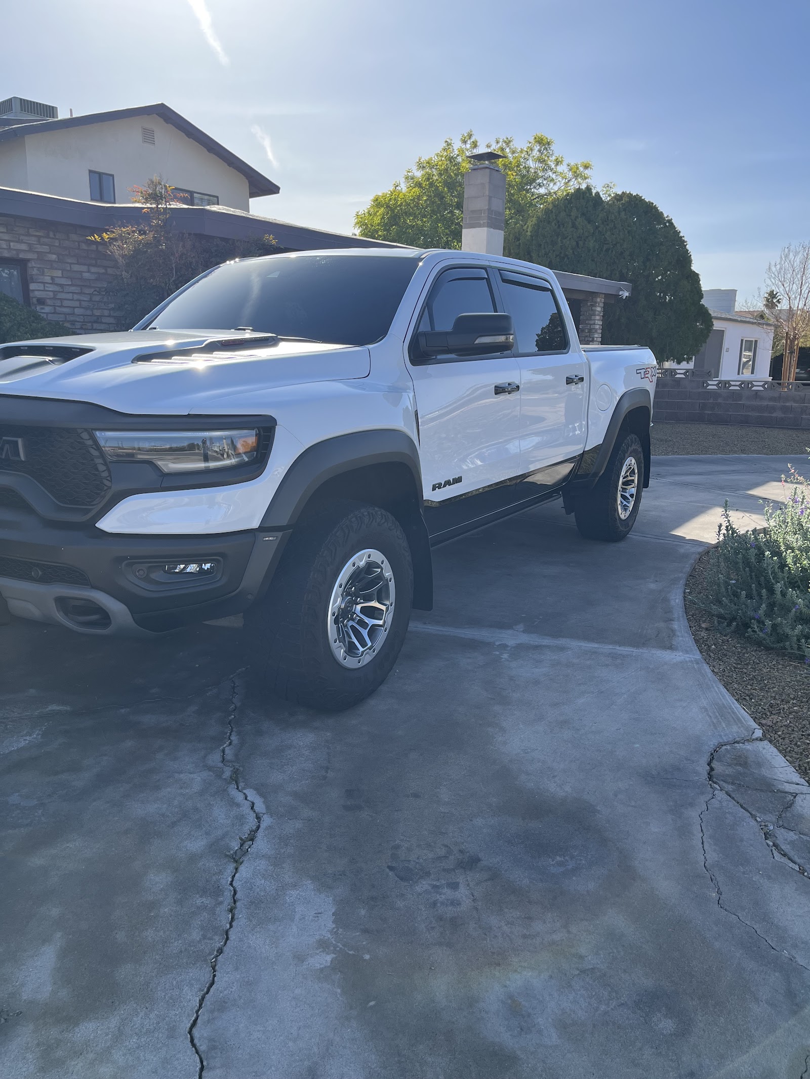 Freshly detailed white Ram TRX truck glossy in a residential driveway