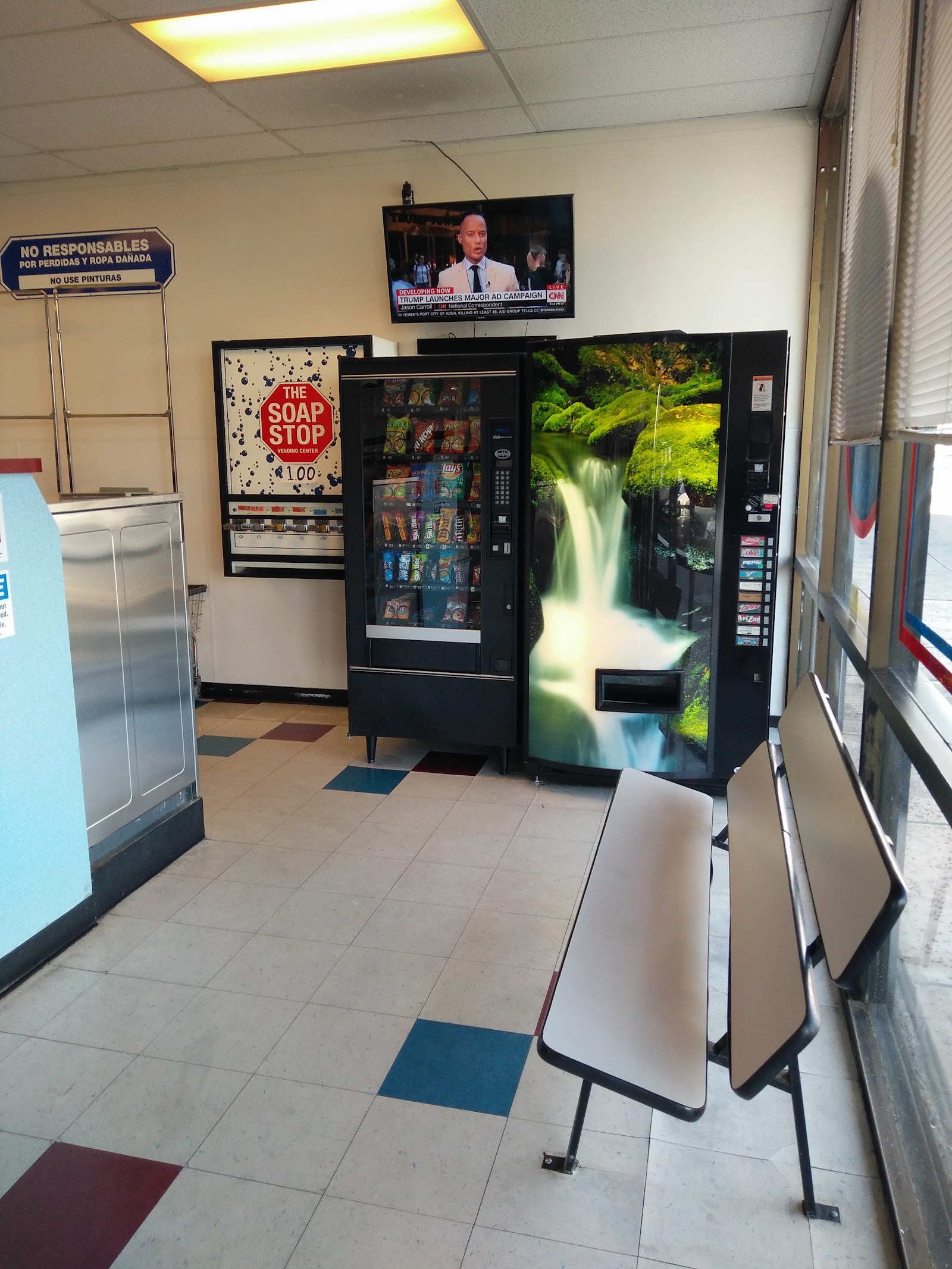 Vending area with snack and drink machines, soap vending, seating and wall-mounted TV