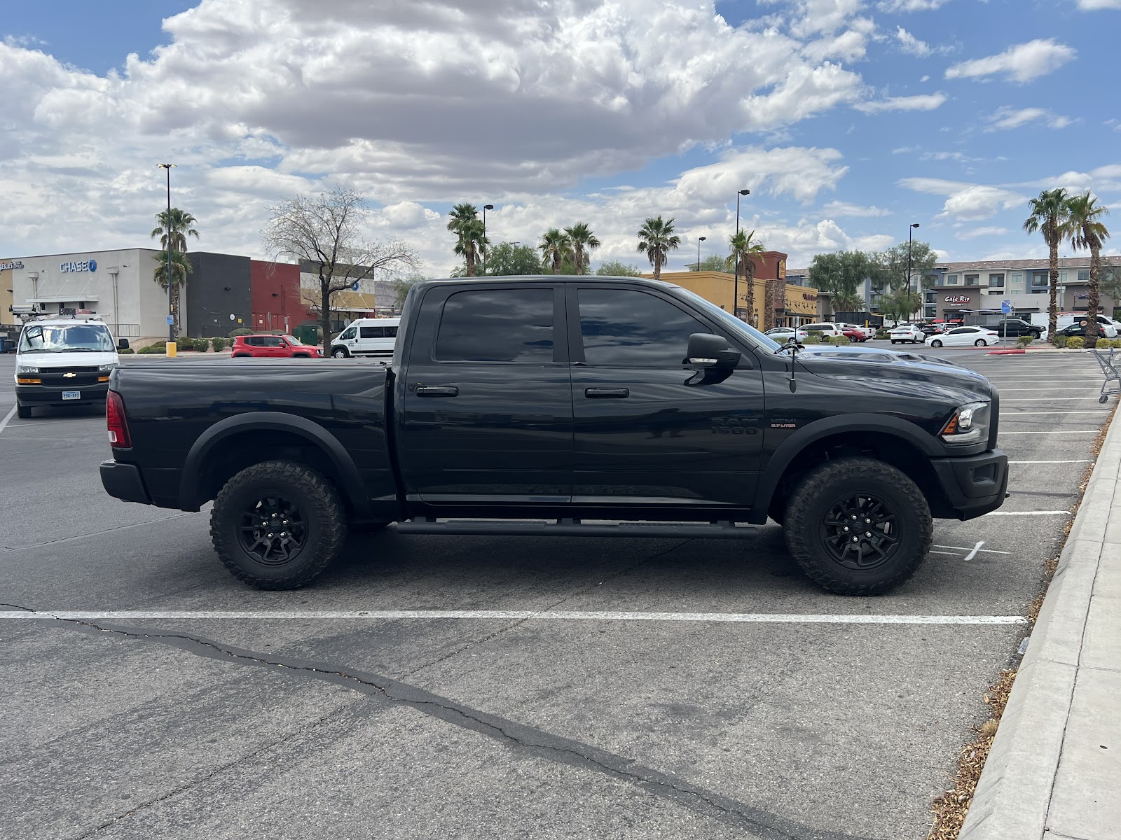 Black Ram 1500 Rebel truck with tinted windows in parking lot