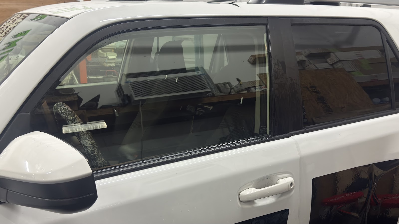 White Toyota 4Runner with tinted rear passenger windows in shop