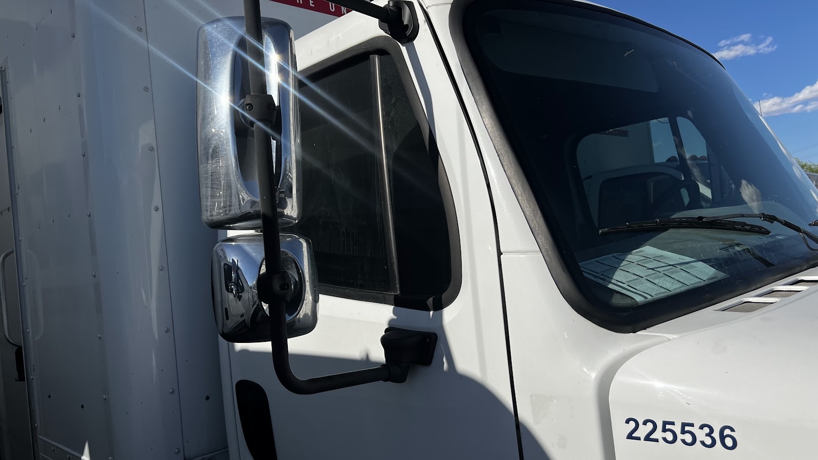 White box truck cab with tinted windows, unit number 225536