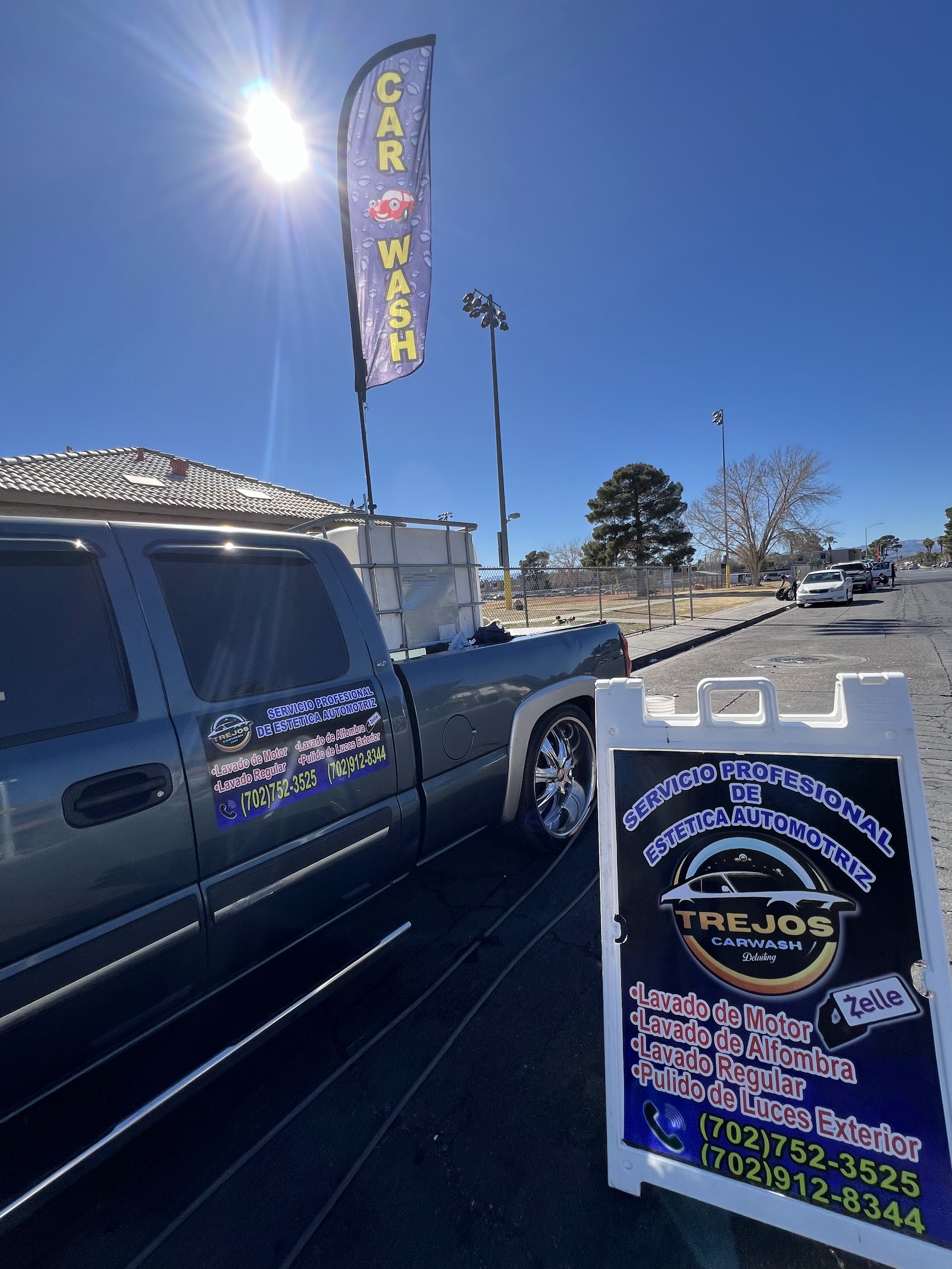 Detailed pickup truck with Trejos Carwash branding and sandwich board sign